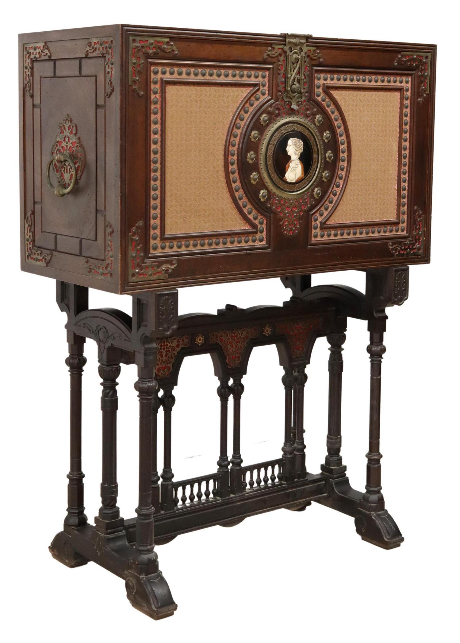 SPANISH RENAISSANCE REVIVAL VARGUENO ON STAND: Spanish Renaissance Revival vargueno on stand, 19th c., fall front with portrait medallion, opening to fitted interior gallery, on stand with pierced metal plaques, colonnaded cross stretcher, approx 