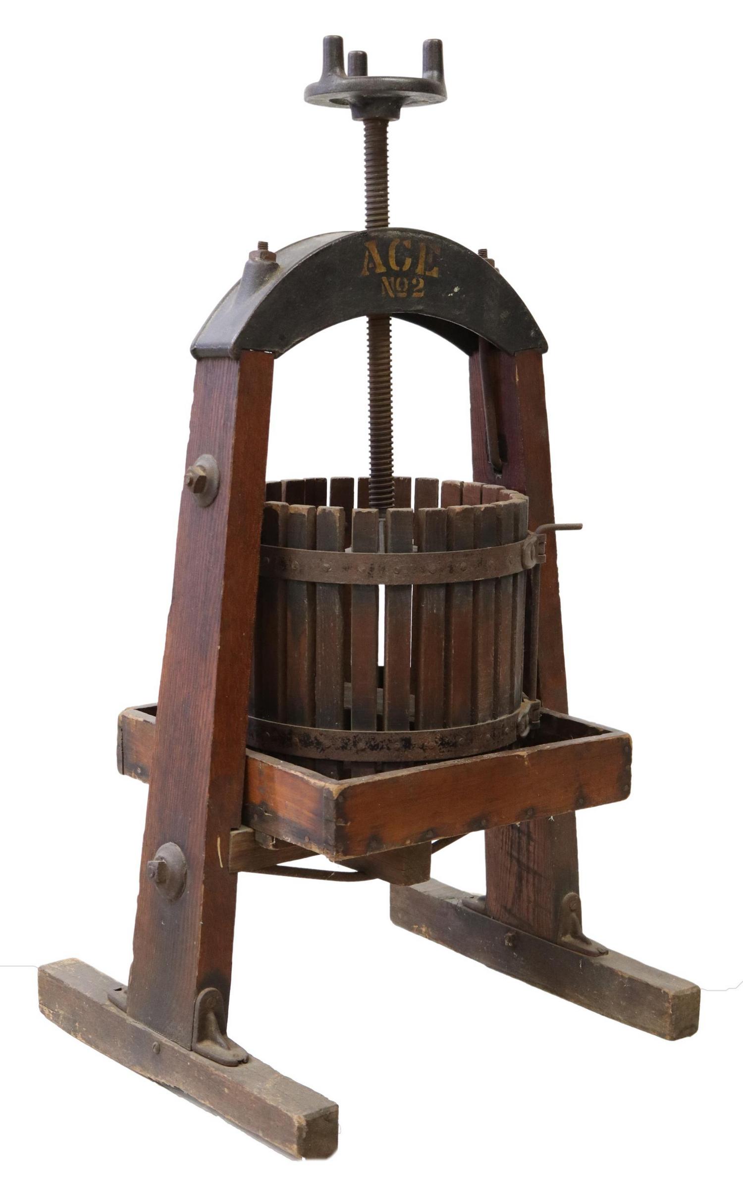 CAST IRON & WOOD FRUIT OR WINE PRESS: Cast iron fruit or wine press, early 20th c., marked ACE no. 2, on an oak trestle stand, approx 41.75"h, 23"w, 20"d Start Price: $100.00