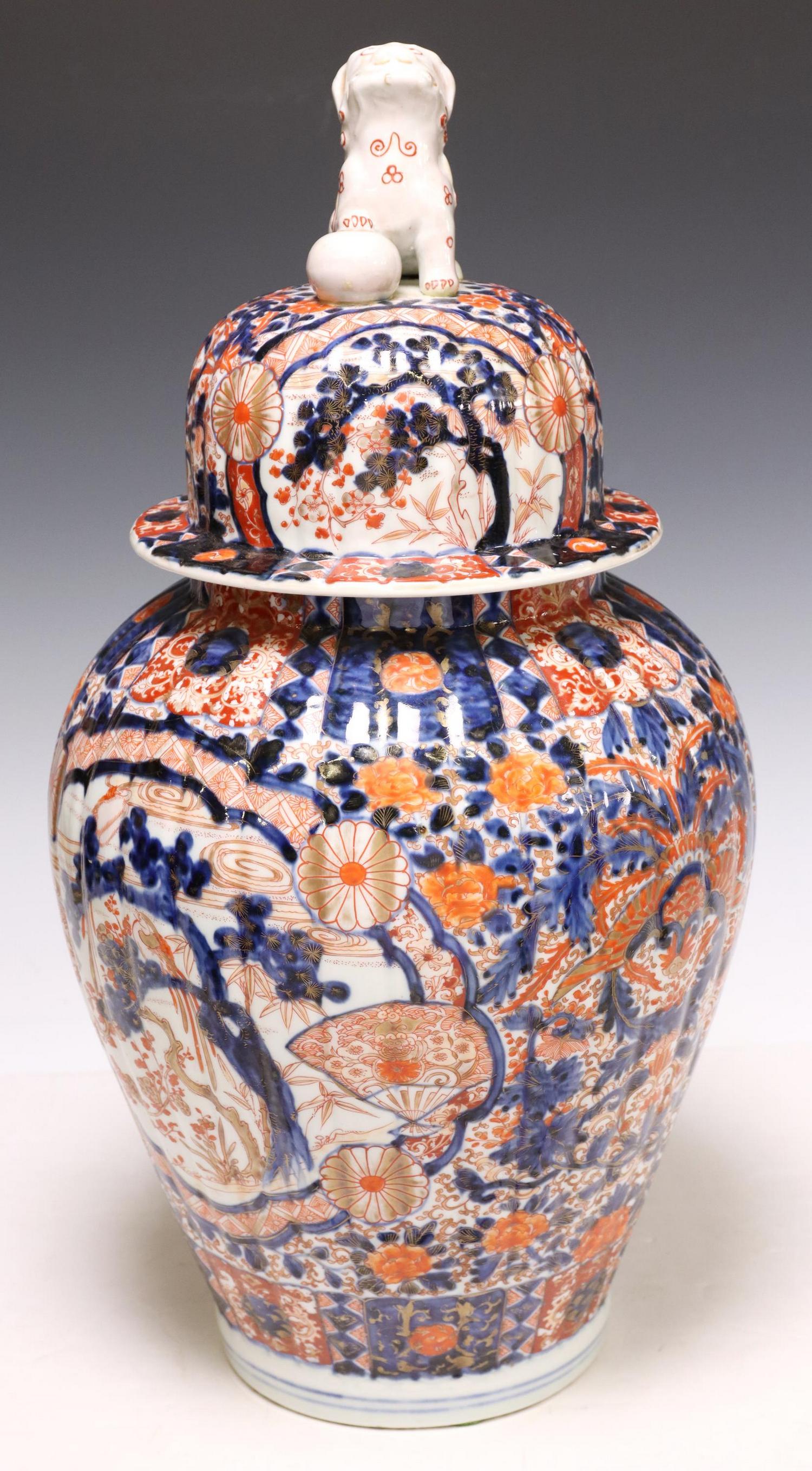 JAPANESE IMARI PORCELAIN FLUTED VASE & COVER: Japanese Imari porcelain lidded vase, domed cover surmounted by a foo lion finial, tapered body with reserves of birds, flowers, approx 21"h, 11 1/8"diam, 14.5lbs **Provenance: A prominent Houstonian'