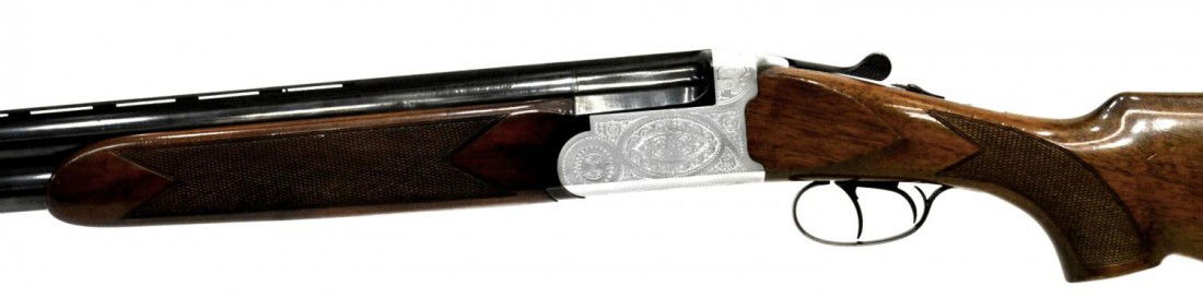 ANTONIO ZOLI OVER UNDER 12 GAUGE SHOTGUN, ENGRAVED: Sears Roebuck Antonio Zoli & Company, over-under 12 gauge shotgun, Model 281.512650, 28” vent rib barrel, walnut partial checkered stock and forearm, engraved receiver, with Gun Guard hard plastic c