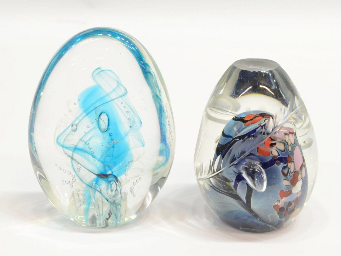 (2) ROLLIN KARG ART GLASS PAPERWEIGHT GROUP: (lot of 2) Rollin Karg glass paper weights, comprising: (1) clear with flowing blue with reds, pinks, white, green glitter and black swirling dots and stripes, large controlled air bubbles, two round 