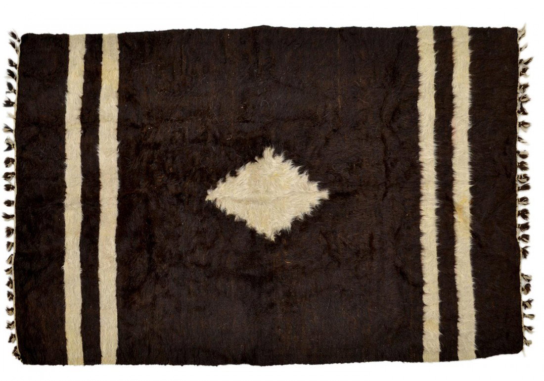COWHIDE RUG ON JUTE, 6'3" x 51": Cowhide and jute rug, 75.5"l, 51"w,