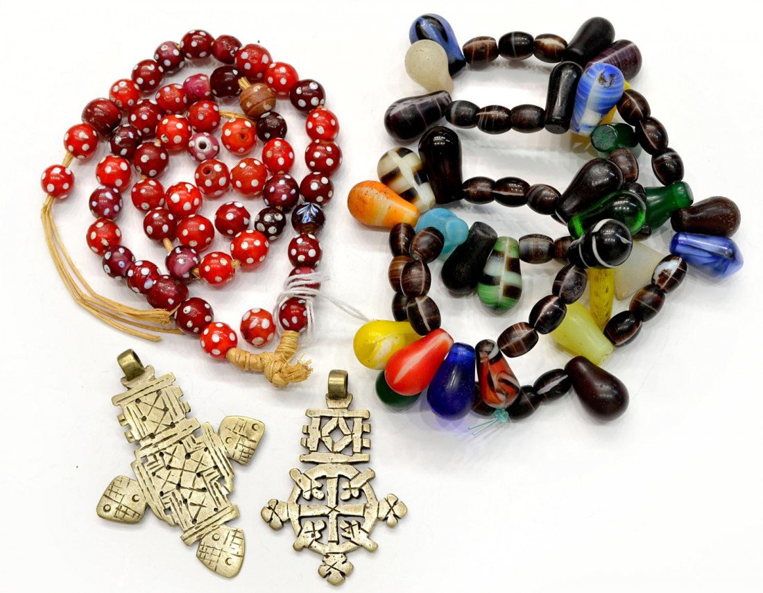 ANTIQUE SNAKE EYES TRADE BEADS, SILVER CROSSES: (lot of 4) Antique trade beads in red 'snake eyes' pattern some loose beads; together with an African beaded necklace, one bead broken, approx 20"; (2) tribal silver cross pendants with pierced motifs