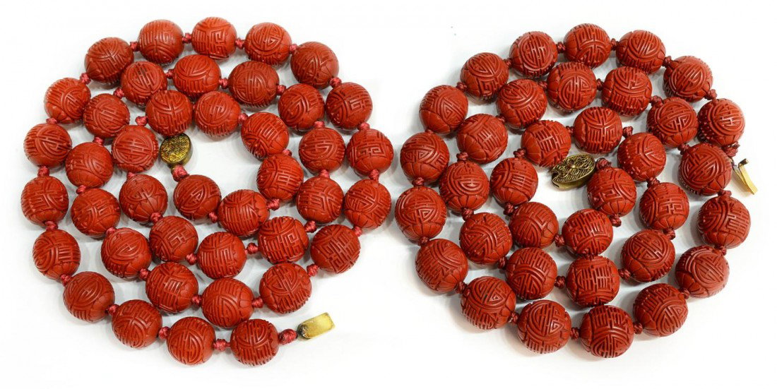 CHINESE CARVED CINNABAR BEAD NECKLACE: (lot of 2) Chinese cinnabar beaded necklaces with carved symbols, each individually knotted, and joined by filigree silver clasp, one: 25"l , the other: 29.5"l, .25lbs total **Provenance: From the est