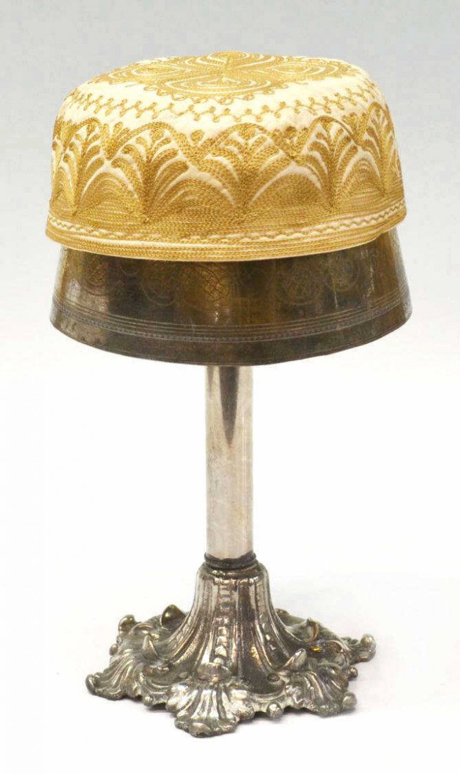 (2) OTTOMAN EMPIRE TURKISH FEZ STAND & FEZ: (lot of 2) Ottoman Empire fez stand, Turkey, early 20th c., silver plate with floral and lattice engraving, cylindrical standard rising on stylized foliate base, standard fitting loosely on later base