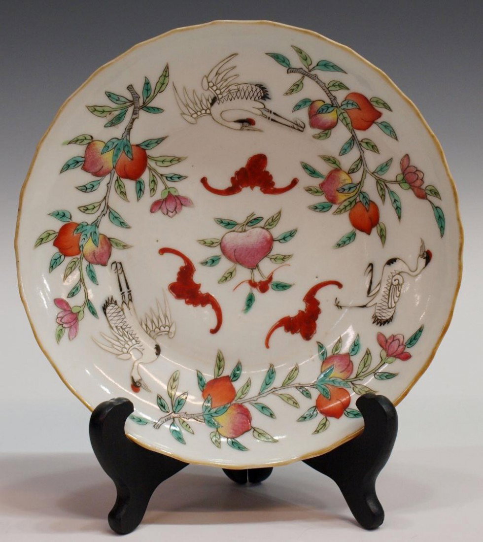 CHINESE TONGZHI PERIOD ENAMELED PORCELAIN DISH: Chinese enameled porcelain plate, Tongzhi Mark and of the Period (1861-1875), the shallow circular dish polychrome enameled with fruiting peach branches, cranes and bats, some pitting, plate: 7.5" dia