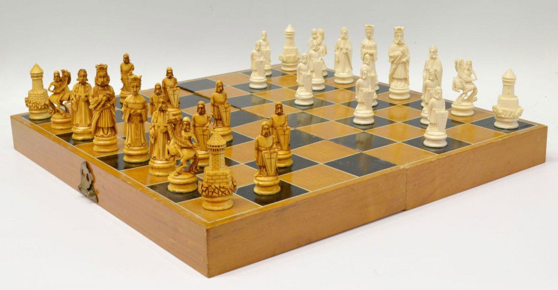 CHINESE CARVED IVORY CHESS SET: **This item will not be shipped Internationally** Large carved ivory chess set, the 32 playing pieces carved as English royalty, the largest 4"h, all housed in a wood case that when opened serves as t
