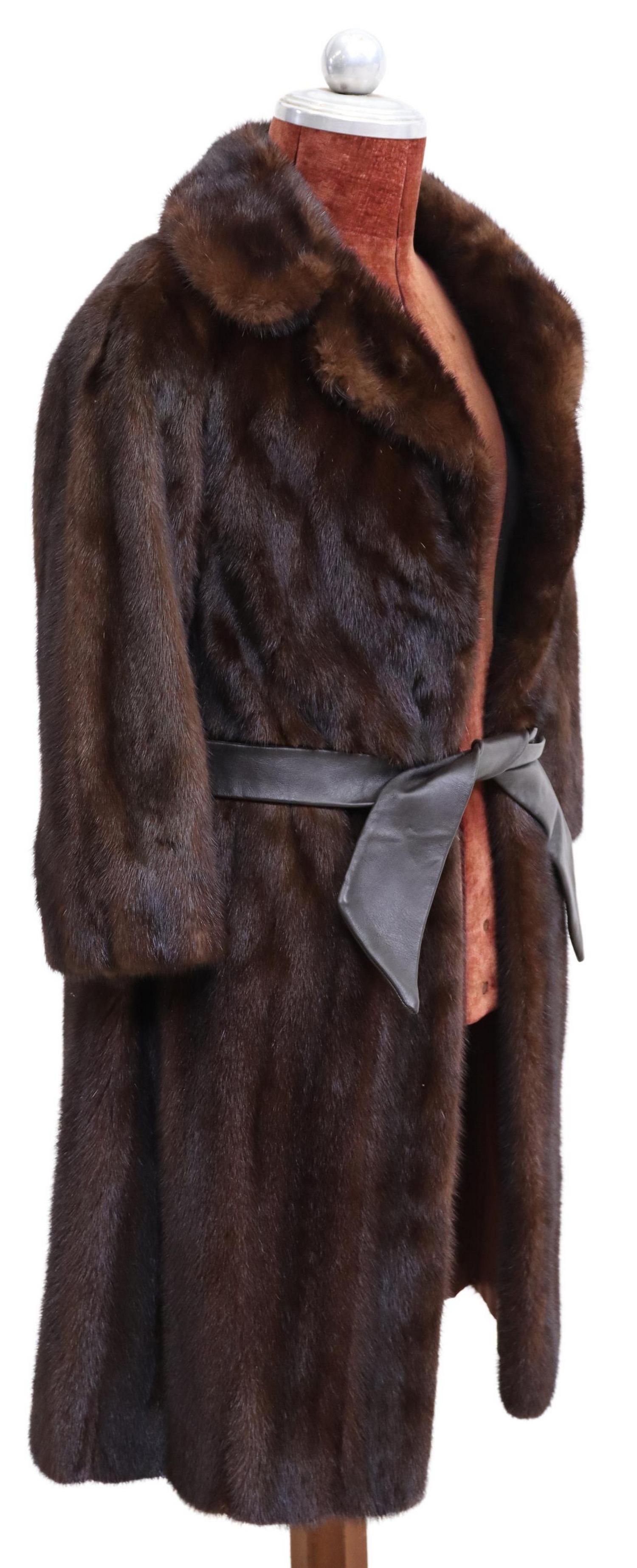 LADY'S BERKSHIRE FURS BROWN MINK FUR COAT: Lady's brown mink fur coat, retailed by Berkshire Furs, Merrimack, New Hampshire, having brown satin lining with embroidered "NT" monogram, dual front pockets, front hook and clasp closure, accompanie