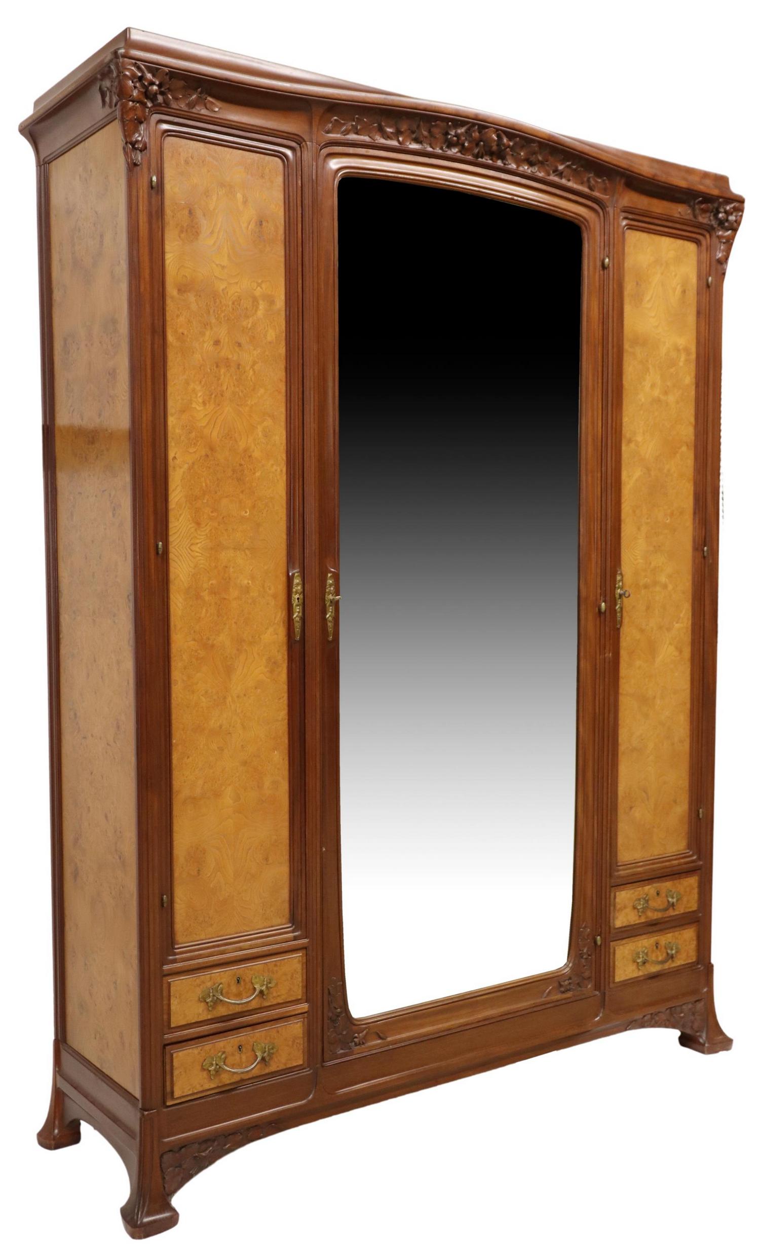 FRENCH ART NOUVEAU MAHOGANY & BURLWOOD ARMOIRE: French Art Nouveau mahogany and burlwood armoire, in the manner of Louis Majorelle (French, 1859-1926), early 20th c., carved frieze with stylized flowers, three doors, center door faced with beveled 