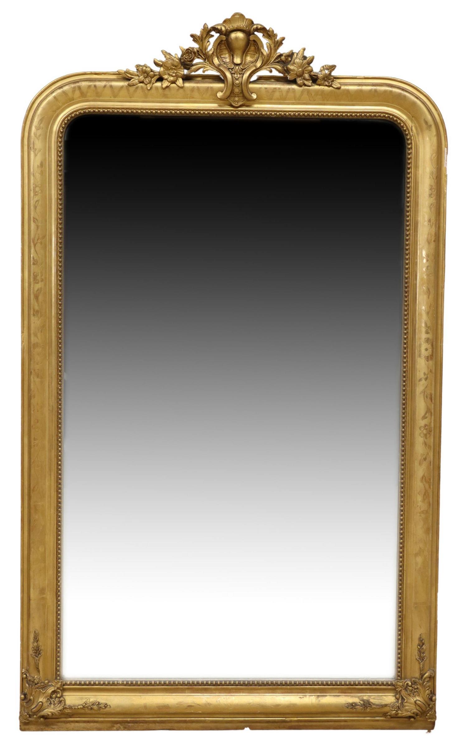 FRENCH LOUIS XV STYLE GILTWOOD WALL MIRROR: French Louis XV style giltwood wall mirror, 19th c., having pierced rocaille crest, over floral embossed frame, encasing flat mirror plate, some gold paint touchups and some losses to frame, approx 74