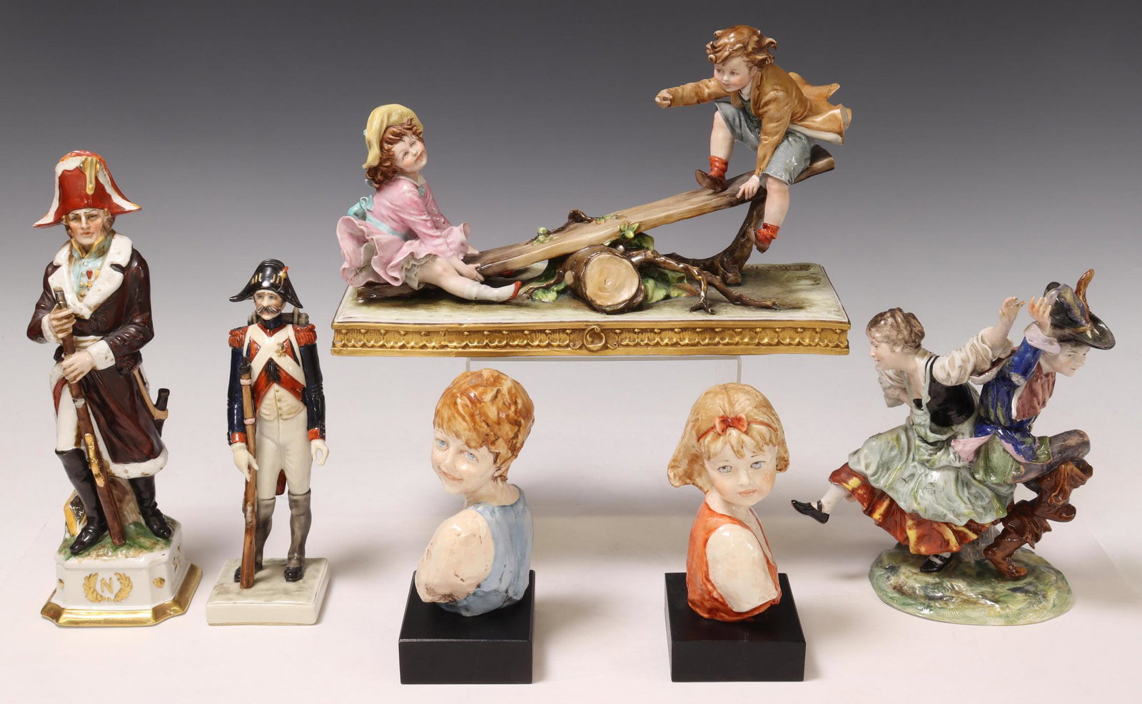(6) ITALIAN PAINTED CERAMIC FIGURES, CAPODIMONTE: (lot of 6) Italian painted ceramic figures, 20th c., including: (2) Capodimonte, with maker's mark at base, (one) depicting children on see saw, signed B. Merli at base, loss to boy's fingers and tree