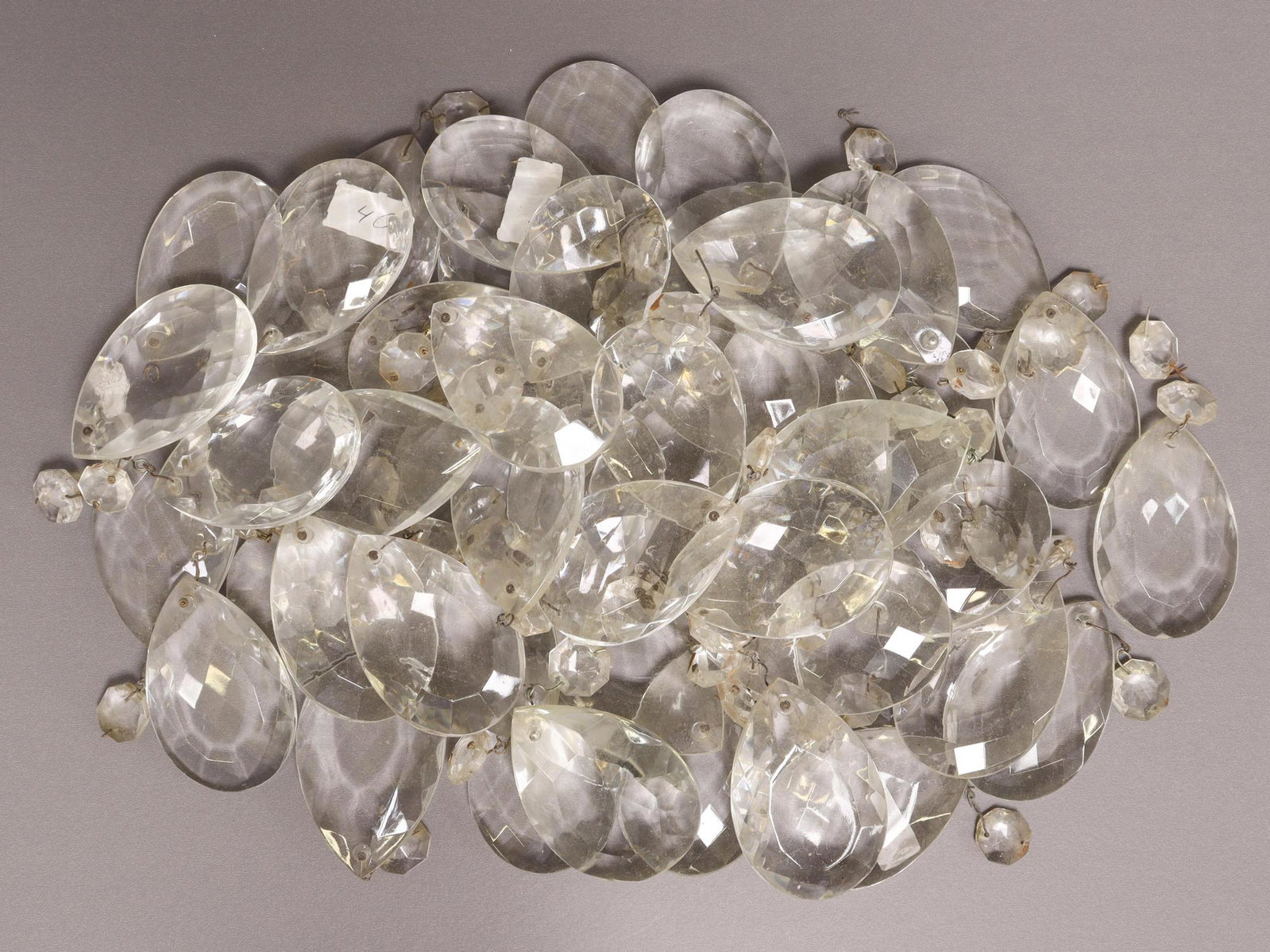 (LOT) ITALIAN CRYSTAL CHANDELIER DROPS & BEADS: (lot) Italian crystal chandelier drops, parts and pieces, including: teardrop pendalogues and faceted beads, typical small chips, largest: approx 3"h, 2"w, 9.2lbs total Start Price: $80.00