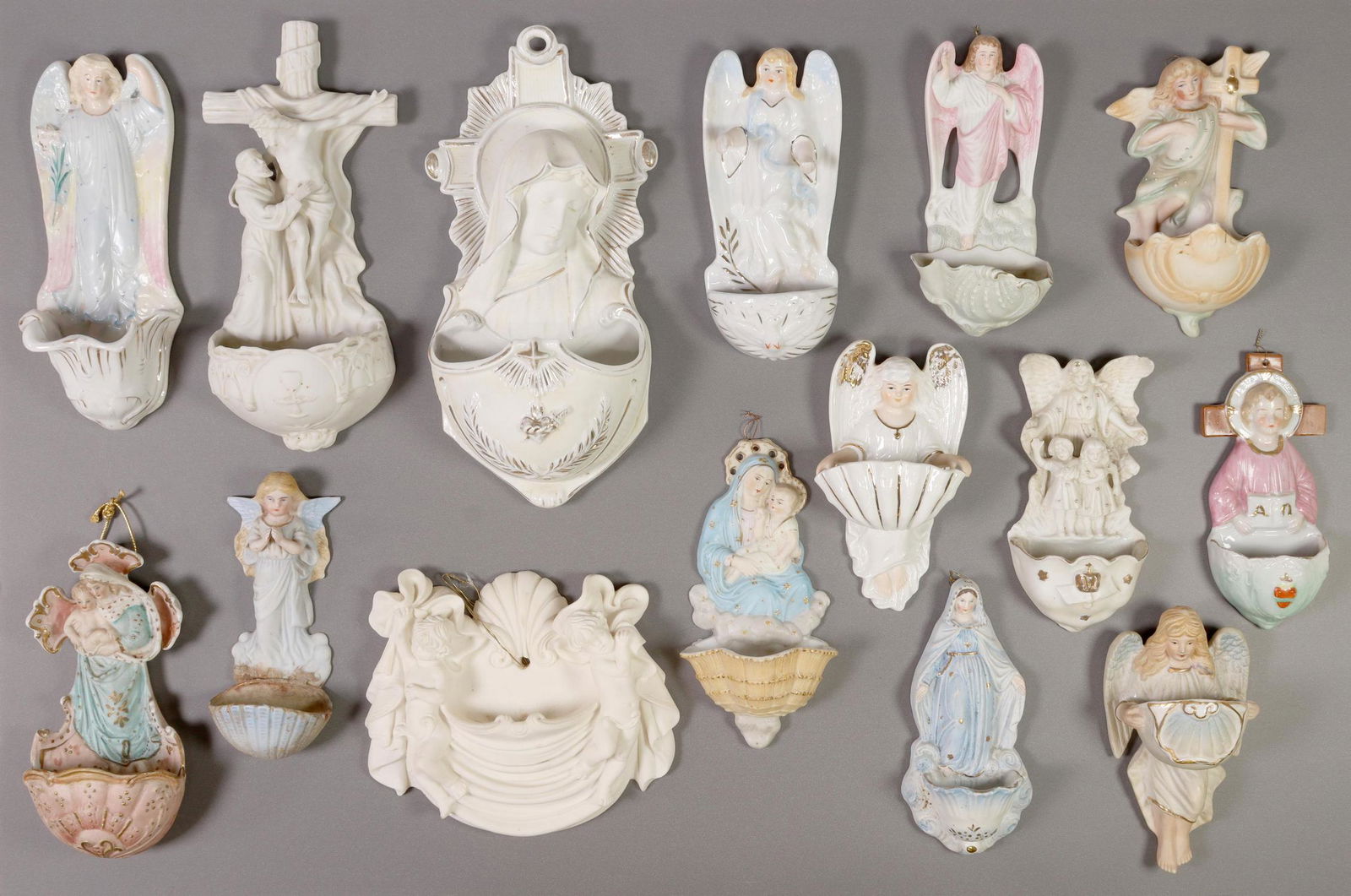 (15) CONTINENTAL PORCELAIN HOLY WATER FONTS: (lot of 15) Continental porcelain holy water fonts, many biscuit/ bisque porcelain examples, (one) cast resin, motifs include the Virgin Mary, angels; largest: approx 10.5"h, 5"w, 8lbs total Start Pri