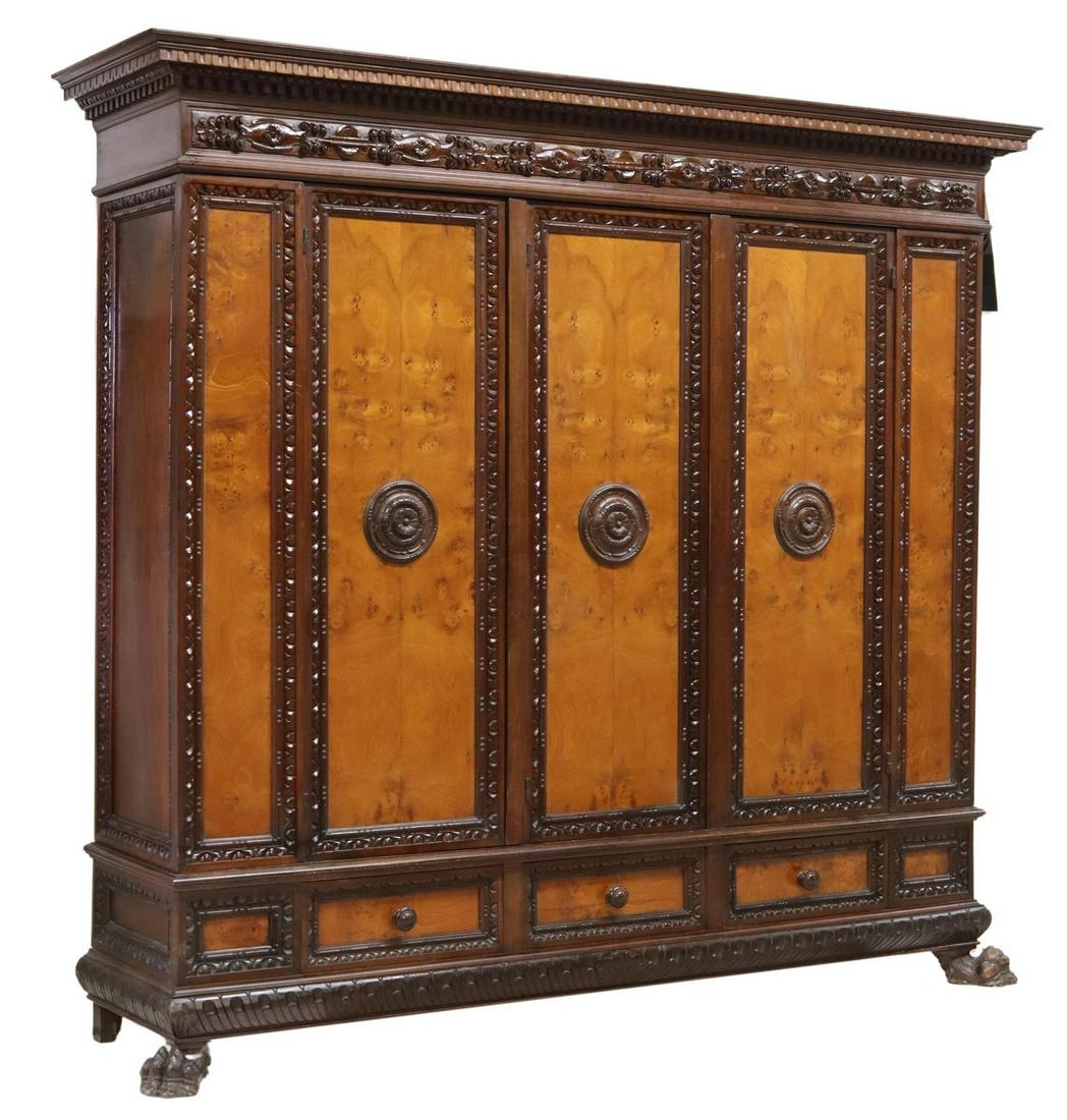 ITALIAN RENAISSANCE REVIVAL BURLWOOD ARMOIRE: Italian Renaissance Revival armoire, Lavinio Bonannini, early 20th c., carved frieze, three cabinet doors with contrasting burlwood panels, over three drawers, on front lion paw feet, approx 85"h, 93.
