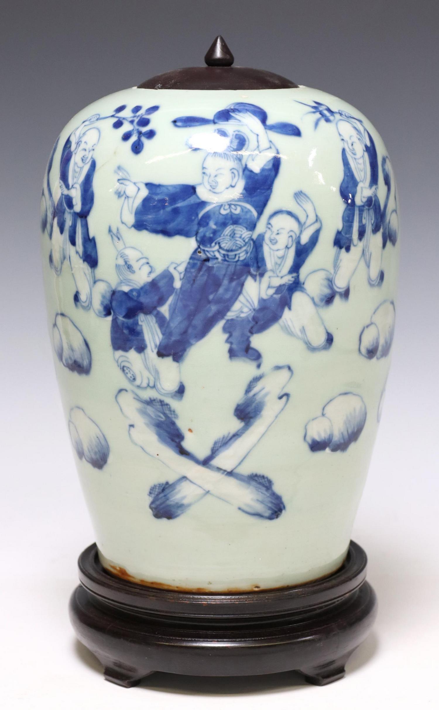 CHINESE BLUE & CELADON PORCELAIN LIDDED MELON JAR: Chinese blue and celadon porcelain melon jar, having later wood lid, depicting figural dancing scene, accompanied by wood stand, approx 12"h, 8" diam, stand: approx 2.25"h, 6.5lbs Start Price: $100.00