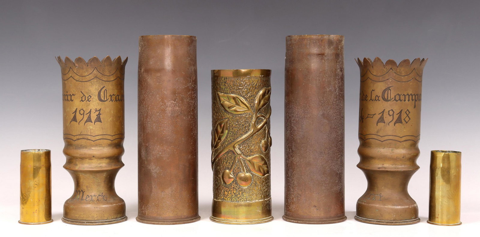 7) FRENCH WWI-ERA TRENCH ART ARTILLERY SHELL VASES: (lot of 7) French WWI-era trench art vases, fashioned from artillery shells, including: (2) having scalloped rim, over waisted base, (one) inscribed "Souvenir de la Champagne," (one) inscribed "Souven