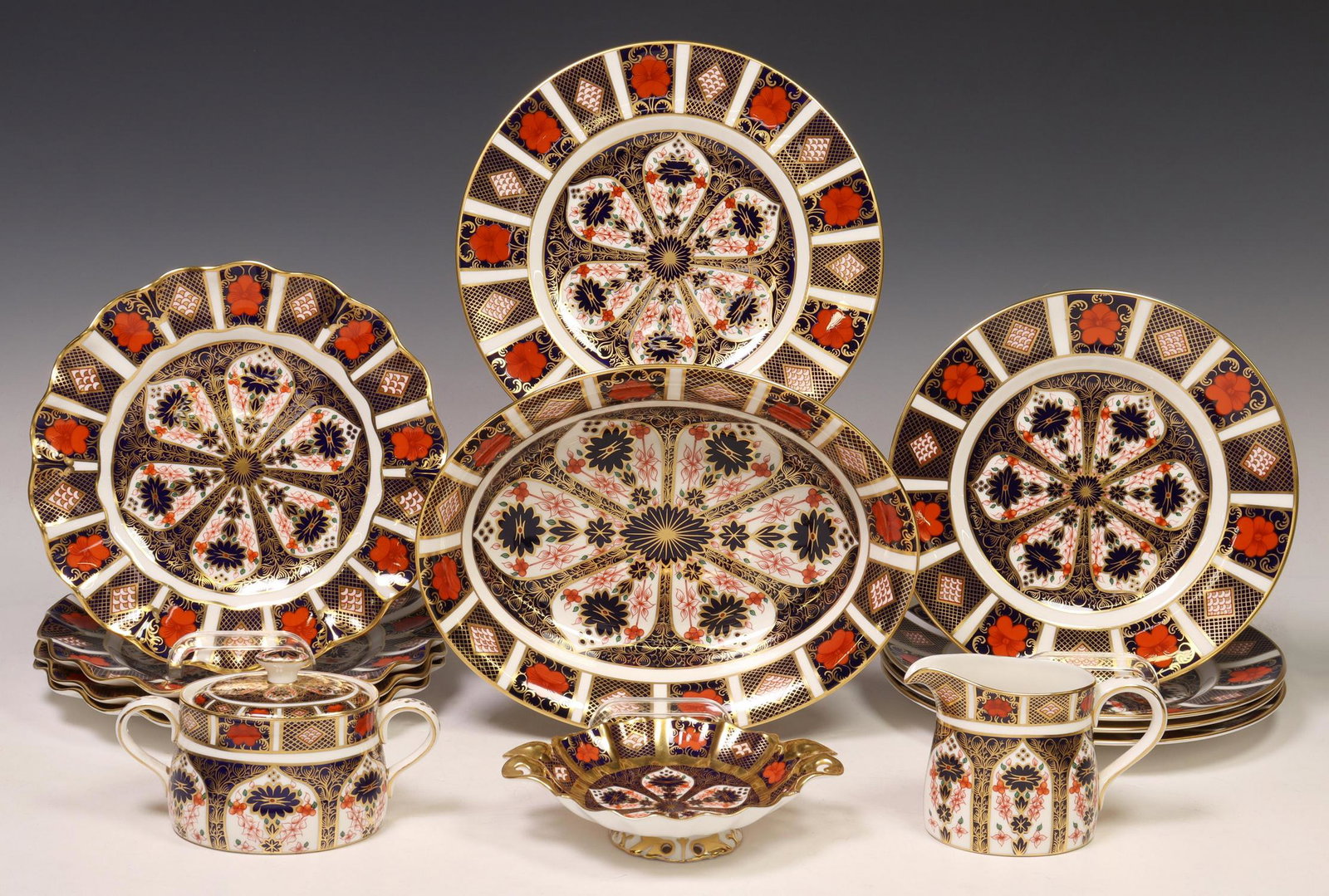 (13) ROYAL CROWN DERBY 'OLD IMARI' BONE CHINA: (lot of 13) English bone china dessert service, Royal Crown Derby, in the "Old Imari" pattern, no. 1128, assembled, including: (1) luncheon plate, approx 9 1/8"diam, (8) salad plates, (four) with scal