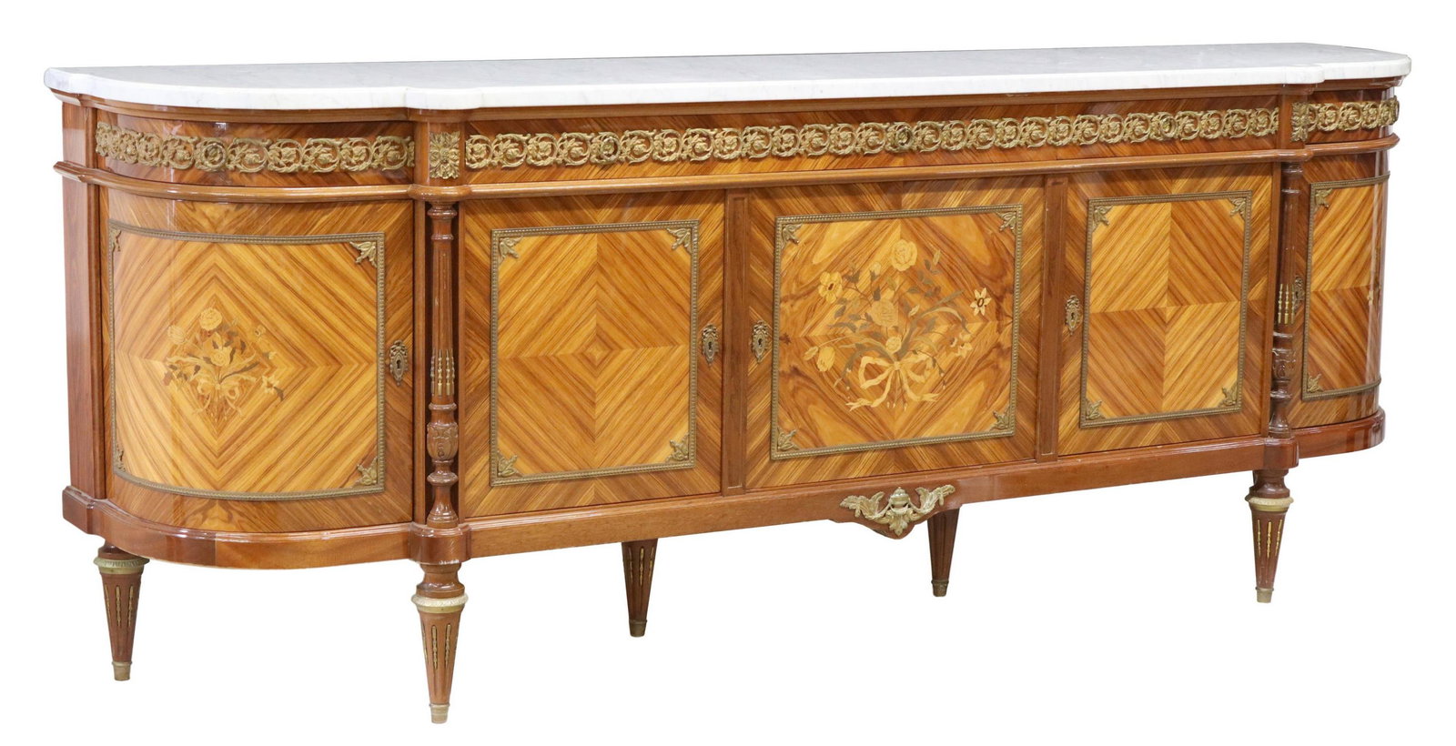 FRENCH LOUIS XVI STYLE MARBLE-TOP SIDEBOARD: French Louis XVI style marble-top sideboard, 20th c., case with curved ends, fitted with five drawers, over five cabinet doors, accented with floral marquetry, rising on tapering fluted legs, approx 4