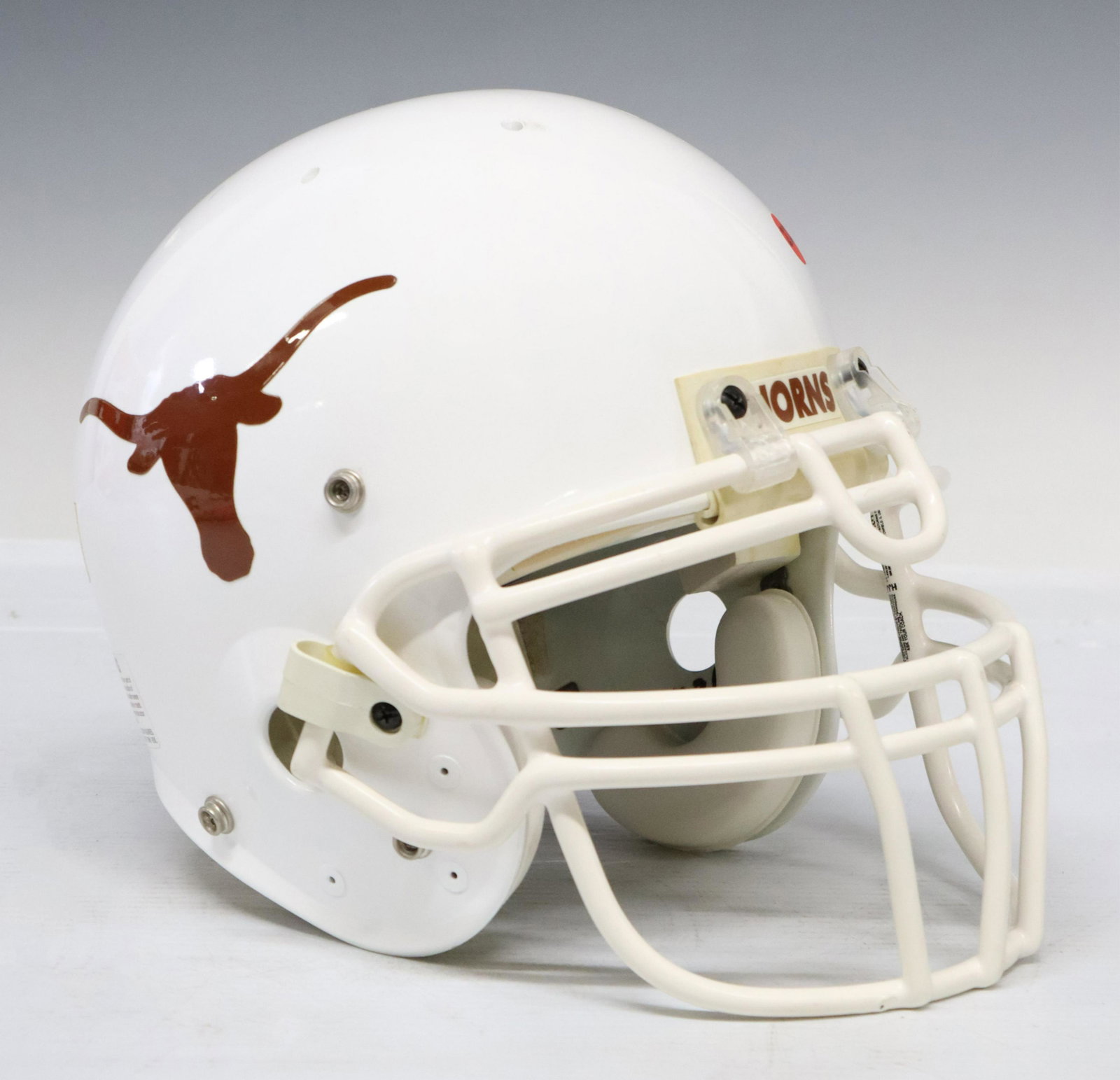 UNIVERSITY OF TEXAS FOOTBALL HELMET, MACK BROWN: University of Texas regulation football helmet signed at the left side by Mack Brown, the helmet interior retains the Mack Brown named price tag of TexasSports.com, for shipping approx. 10.25"h, 12.75