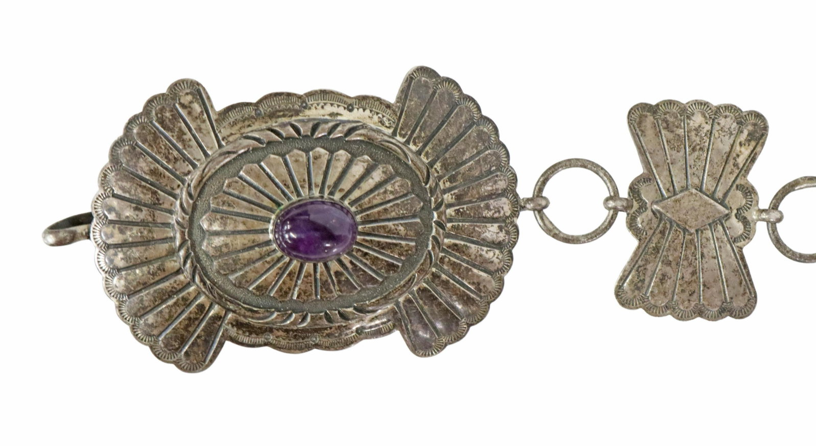 FRED THOMPSON NAVAJO STERLING AMETHYST CONCHO BELT: Native American sterling silver concho belt, picto hallmark for Fred Thompson (Navajo / Dine, 1922-2002), (one) worked buckle, and (six) oval conchos, each with bezel set amethyst cabochon, separated 