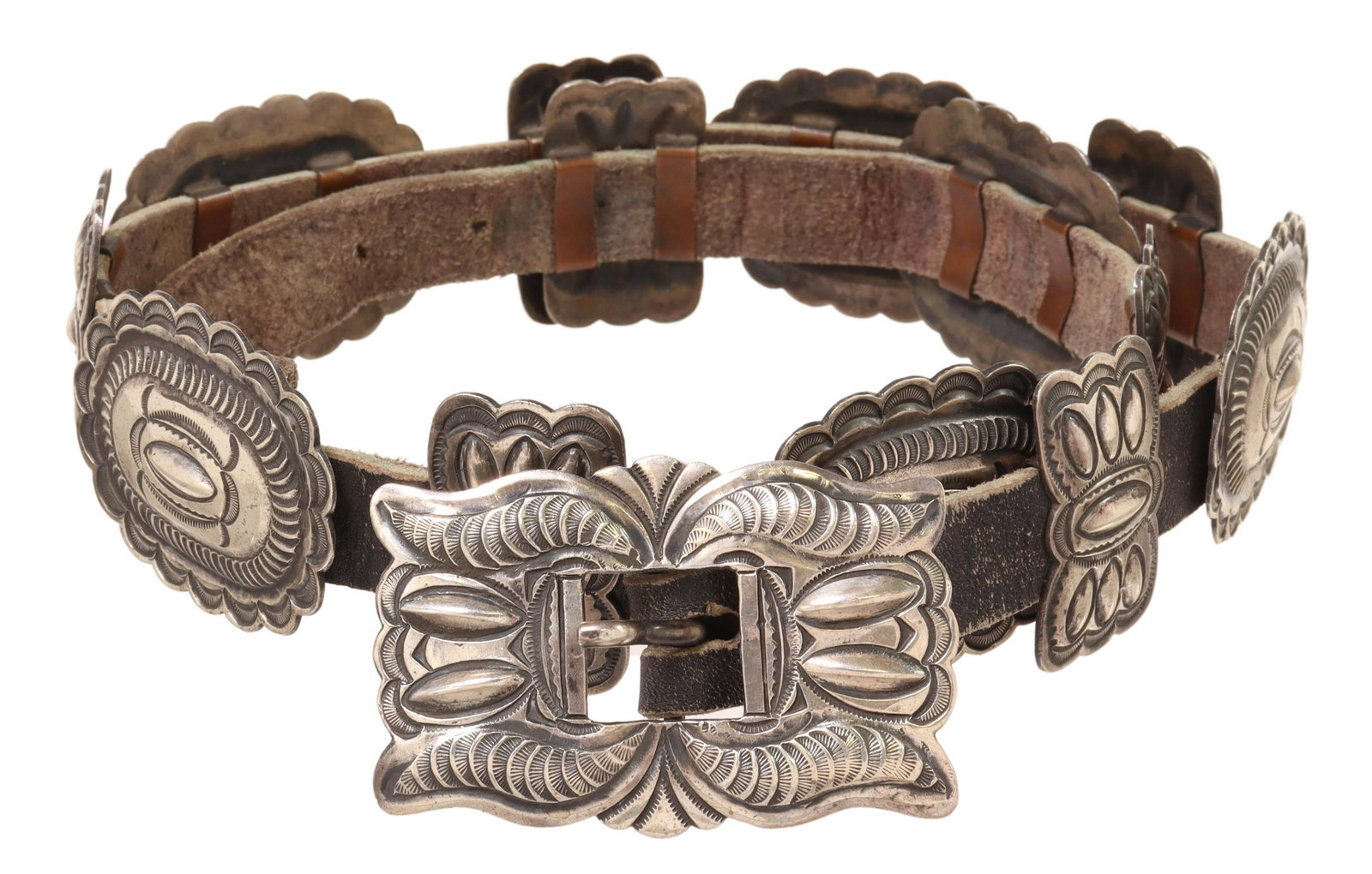 NATIVE AMERICAN STERLING STAMPWORK CONCHO BELT: Native American sterling silver concho belt, signed LE, likely Navajo, having stampwork rectangular belt buckle, six oval conchos, separated by seven butterfly spacers, all on worn leather belt, buckl