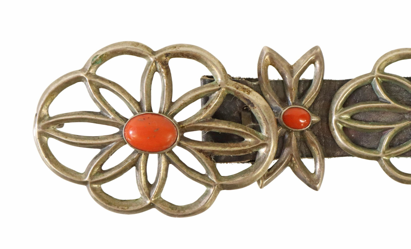 NATIVE AMERICAN SILVER & RED CORAL CONCHO BELT: Native American tufa cast silver (content unknown) concho belt, unmarked, (one) oval buckle, (nine) matched conchos, spaced by (nine) butterfly conchos, each centering an oval red coral cabochon, on a