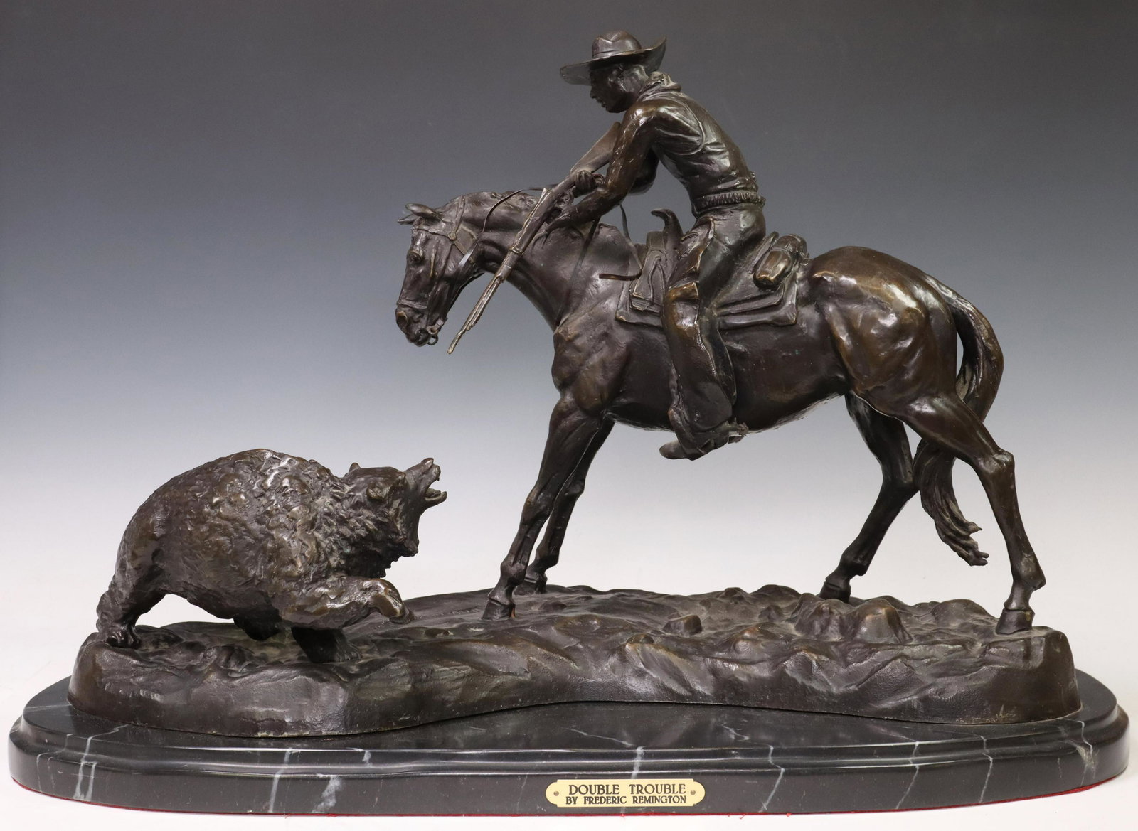 AFTER REMINGTON WESTERN BRONZE, 'DOUBLE TROUBLE': Patinated bronze figural sculpture, "Double Trouble," after the original by Frederic Sackrider Remington (American, 1861-1909), title plaque at front face, rising on marble base, approx 16.5"h, 26"w, 