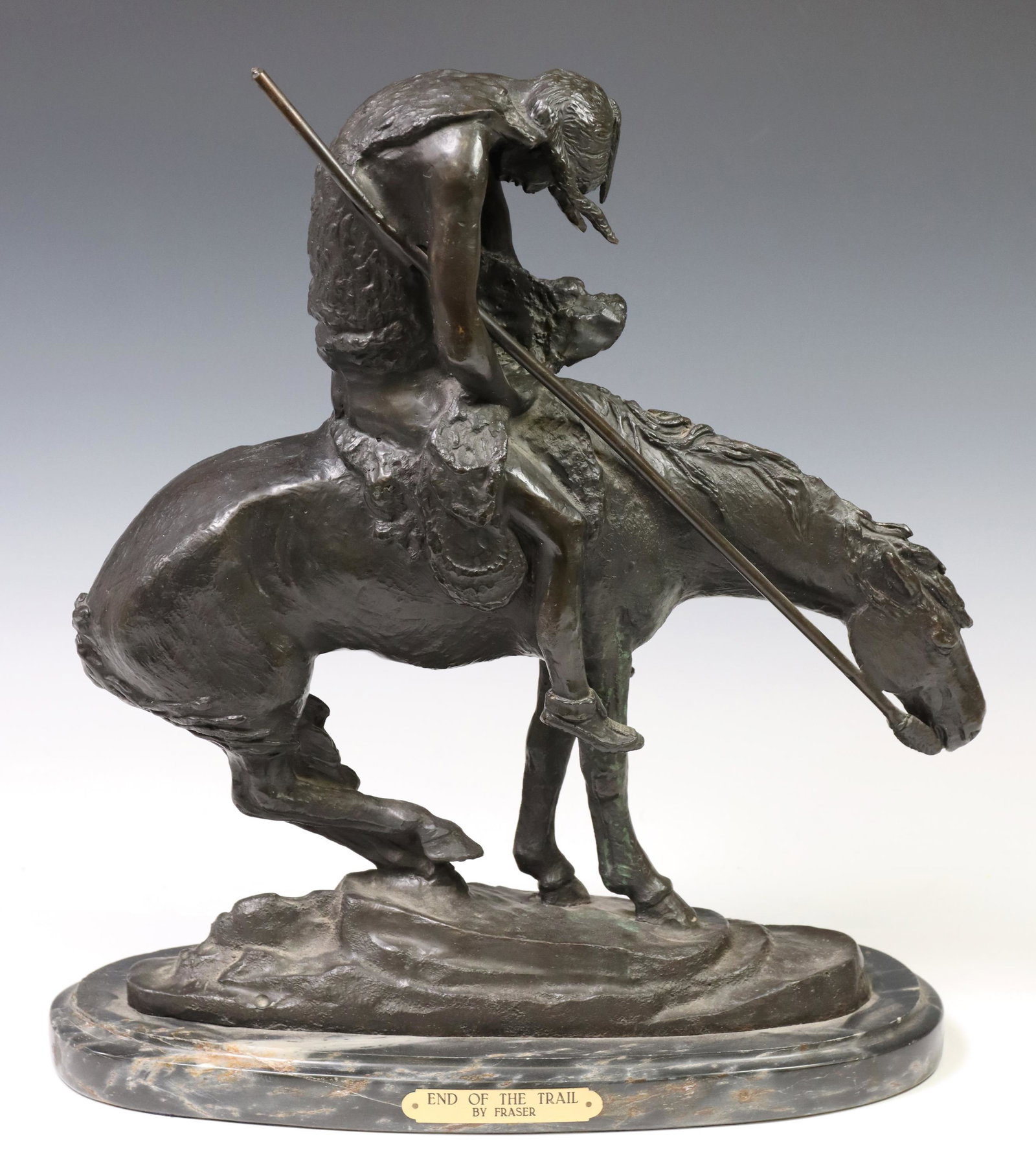 AFTER JAMES E. FRASER BRONZE, 'END OF THE TRAIL': Patinated bronze figural sculpture, "End of the Trail," after the original by J.E. Fraser (James Earle Fraser, American, 1876-1953), numbered 54/100, title plaque at front face, rising on marble base,