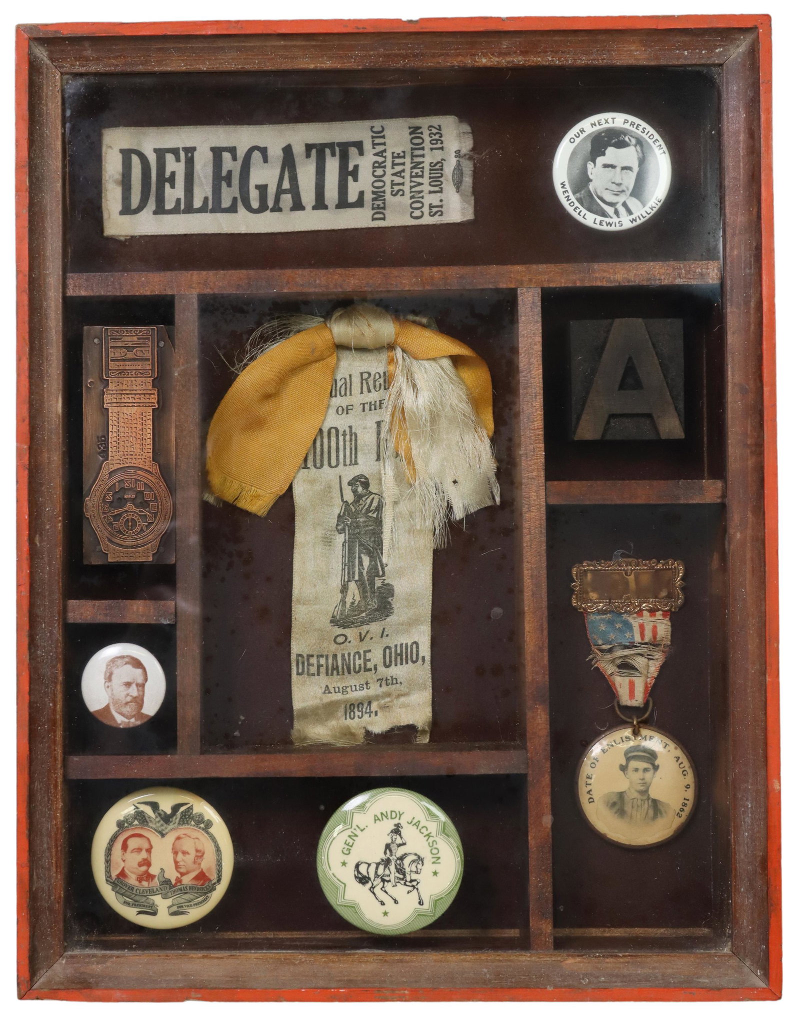 SHADOWBOX FRAMED POLITICAL BUTTONS & EPHEMERA: Wood shadowbox frame, with political campaign buttons, ephemera, and print blocks, highlights include: (1) Wendell Lewis Willkie presidential button, (1) Grover Cleveland and Thomas Hendrick president