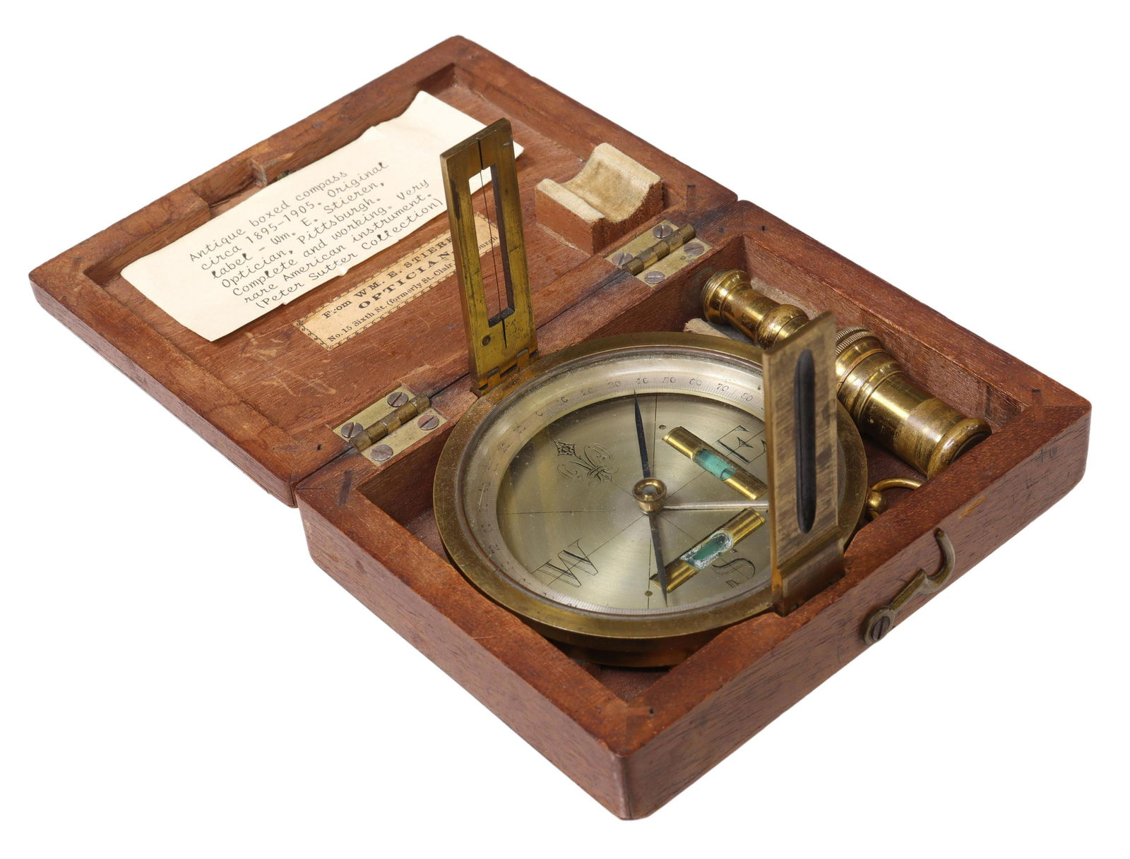 BRASS CASED SURVEYING COMPASS IN MAHOGANY BOX: Brass cased surveying compass, retailed by William E. Stieren (1836-1884), Optician, No. 15 Sixth St. (formerly St. Clair), Pittsburgh, Pennsylvania, late 19th c., two folding sighting vanes, two bubb