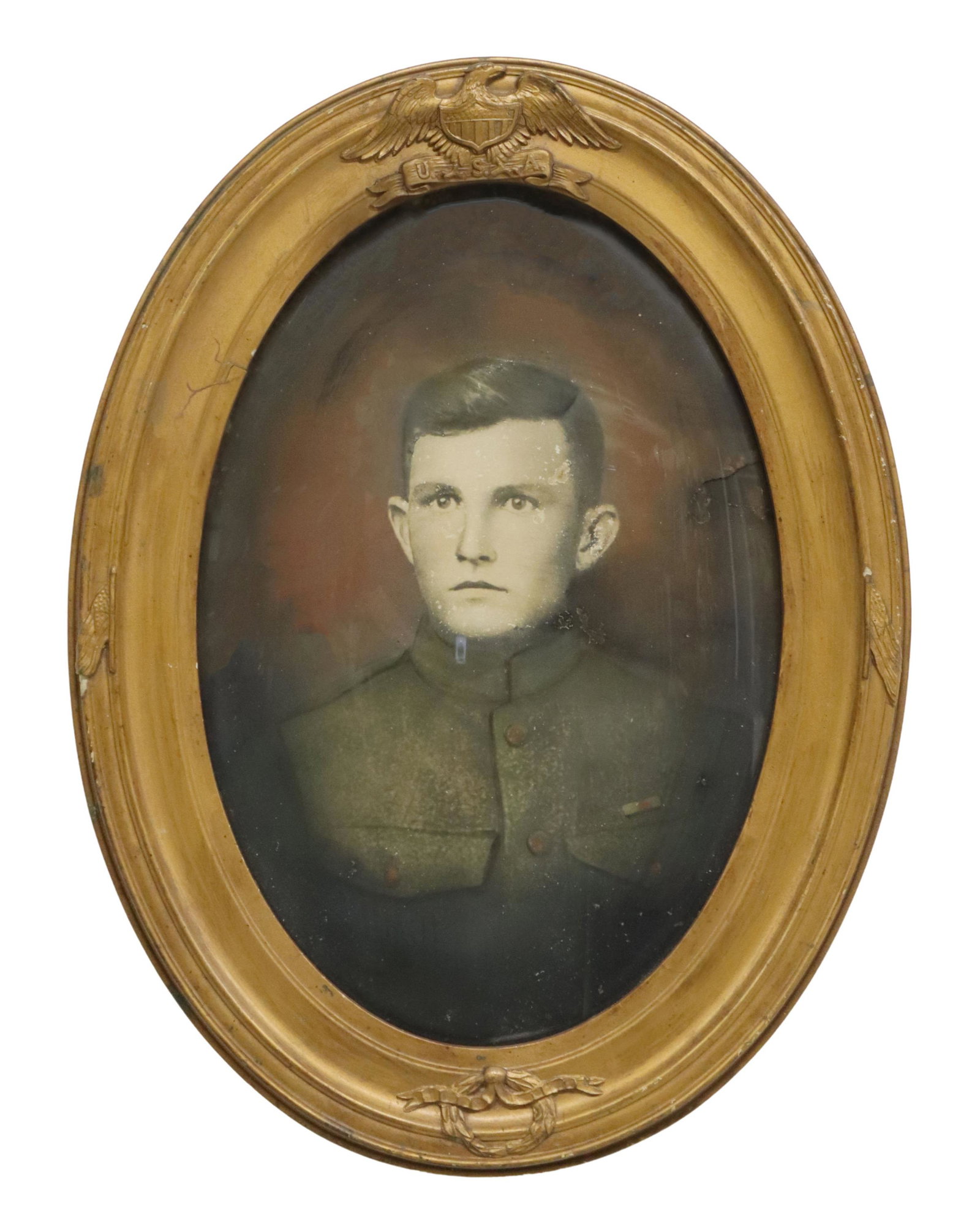 FRAMED WWI U.S. SOLDIER, PATRIOTIC FRAME: Framed U.S. WWI uniformed soldier, the patriotic oval frame with the U.S. eagle and Federal shield over convex glass, flags at each frame left and right, frame: approx 25"h, 18.75"w, 5lbs Start Price: