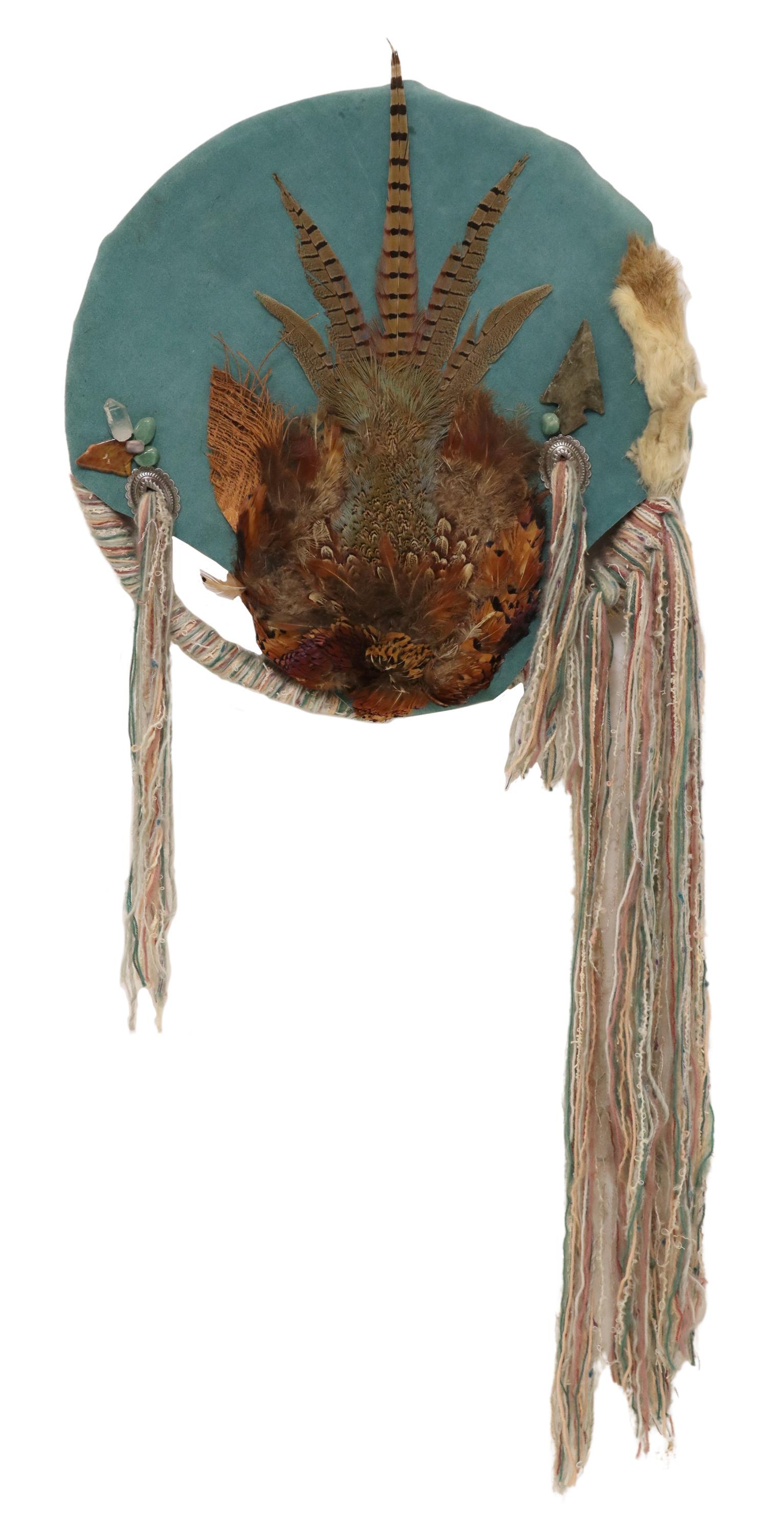 MIXED MEDIA DREAM CATCHER SCULPTURE: Mixed media wall sculpture, Dream Catcher, attributed to Cameron Blagg (American, 20th c.), turquoise-colored suede clad hoop, ornamented with rabbit and pheasant, stones, arrowhead, and stamped conch