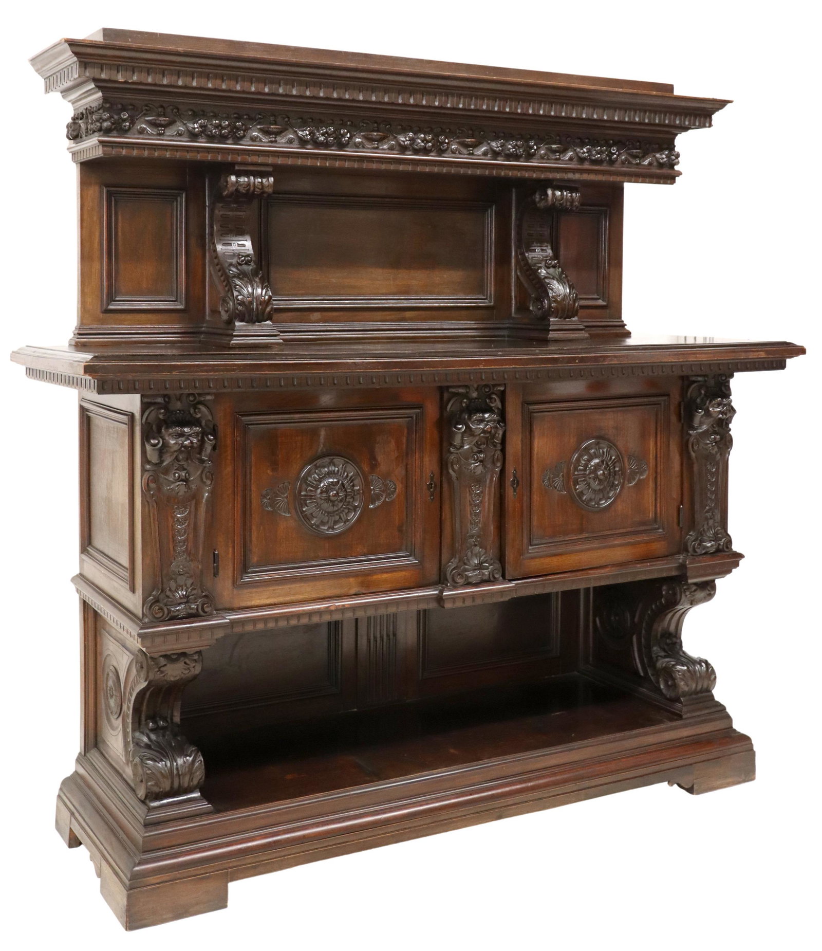 ITALIAN RENAISSANCE REVIVAL CARVED SIDEBOARD: Italian Renaissance Revival carved sideboard, early 20th c., in a dark finish, having molded cornice, the whole in carved fruits and foliates, fitted with two cabinets, rising on bracket legs, approx 