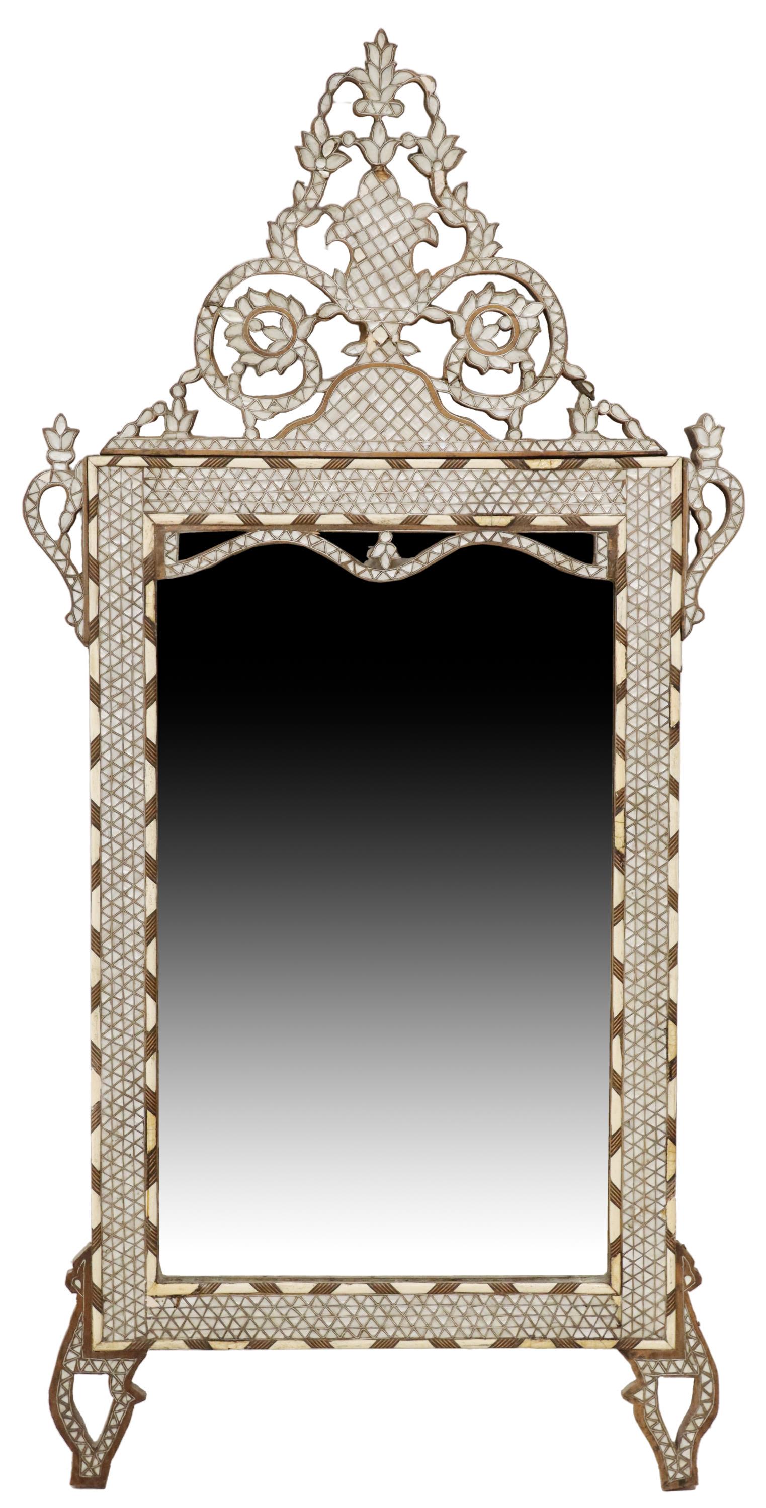 SYRIAN SHELL & BONE INLAID MIRROR, 66.5" X 32.75": Shell and bone inlaid mirror, Syria, 20th c., having pierced scrolling foliate crest, over frame encasing flat mirror plate, rising on shaped feet, some typical small losses and fill restorations, app