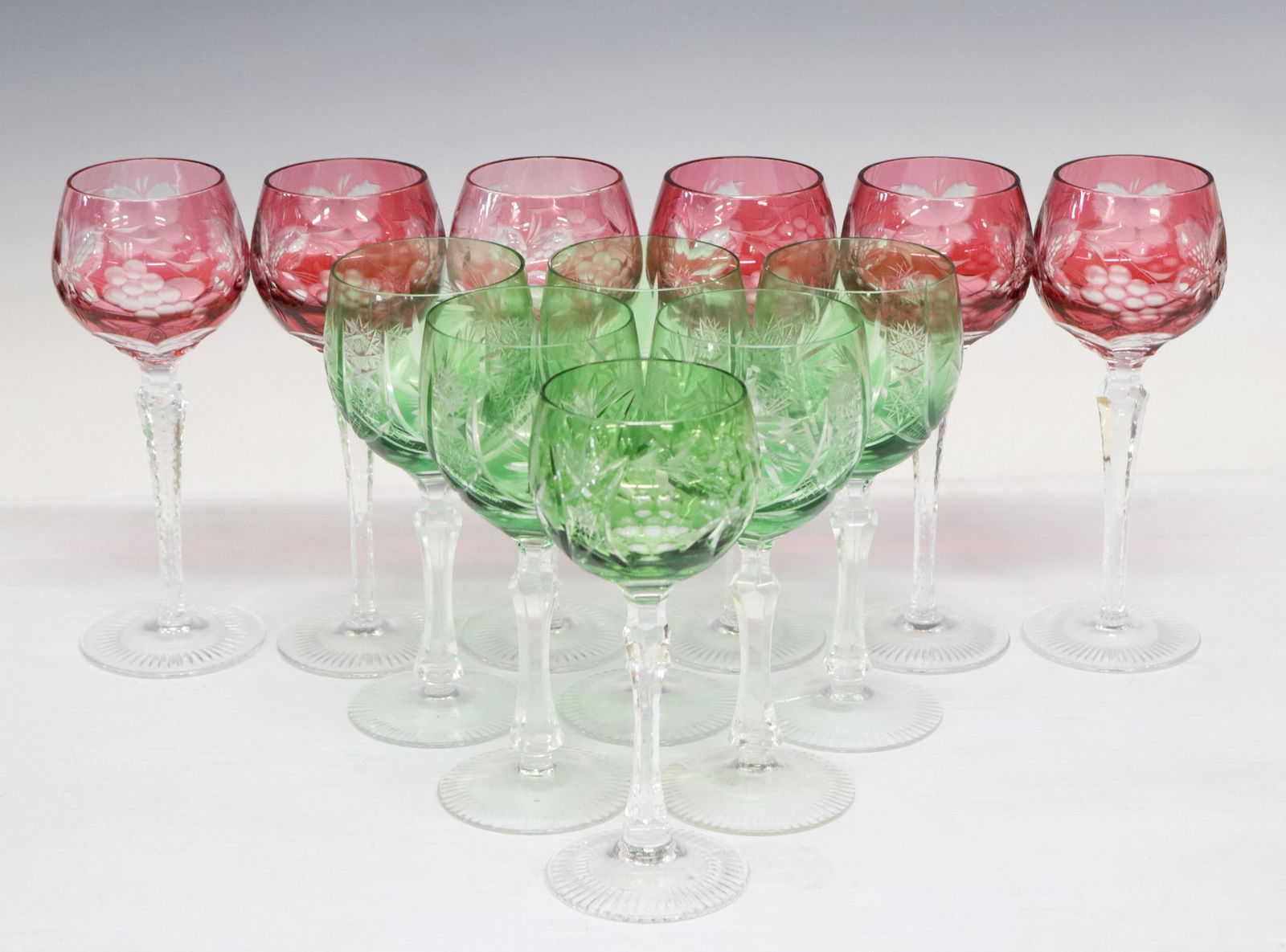 (12) COLLECTION OF CUT TO CLEAR WINE GOBLETS: (lot of 12) Cut to clear crystal wine stems, possibly Bohemian, assorted, in green and red, comprising: (6) green, patterned with hobnails and stars, (five) approx 7.75"h, 3.25" diam, (one) approx 7.5