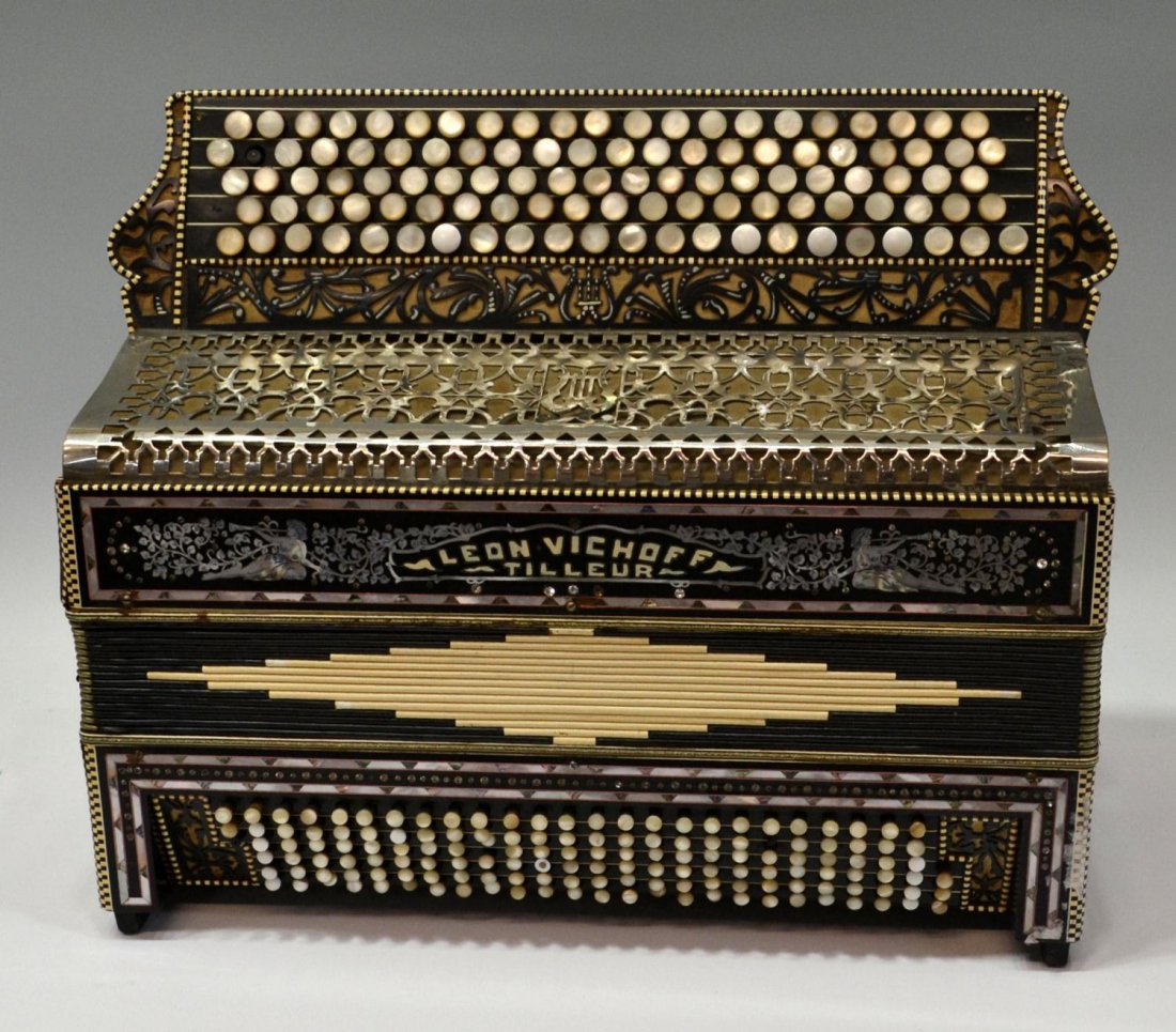 FANCY LEON VICHOF-TILLEUR MOP INLAID ACCORDIAN: Leon Vichoff- Tilleur -Accordion, having mother-of-pearl keys, inlay of two women trumpeting amount foliage and floral inlay design to siding pierced silver tone decoration, crystal like highlights, p