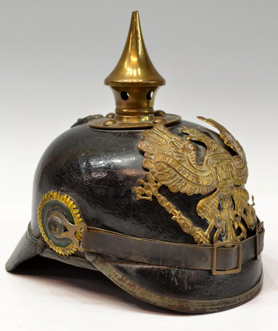 GERMAN PICKELHAUBE SPIKE HELMET PRUSSIA: German pickelhaube helmet fitted with metal front plate depicting the Prussian coat of arms, polished leather body, metal rimmed visor, neck guard, chin strap, one onside green and yellow kokarden, in