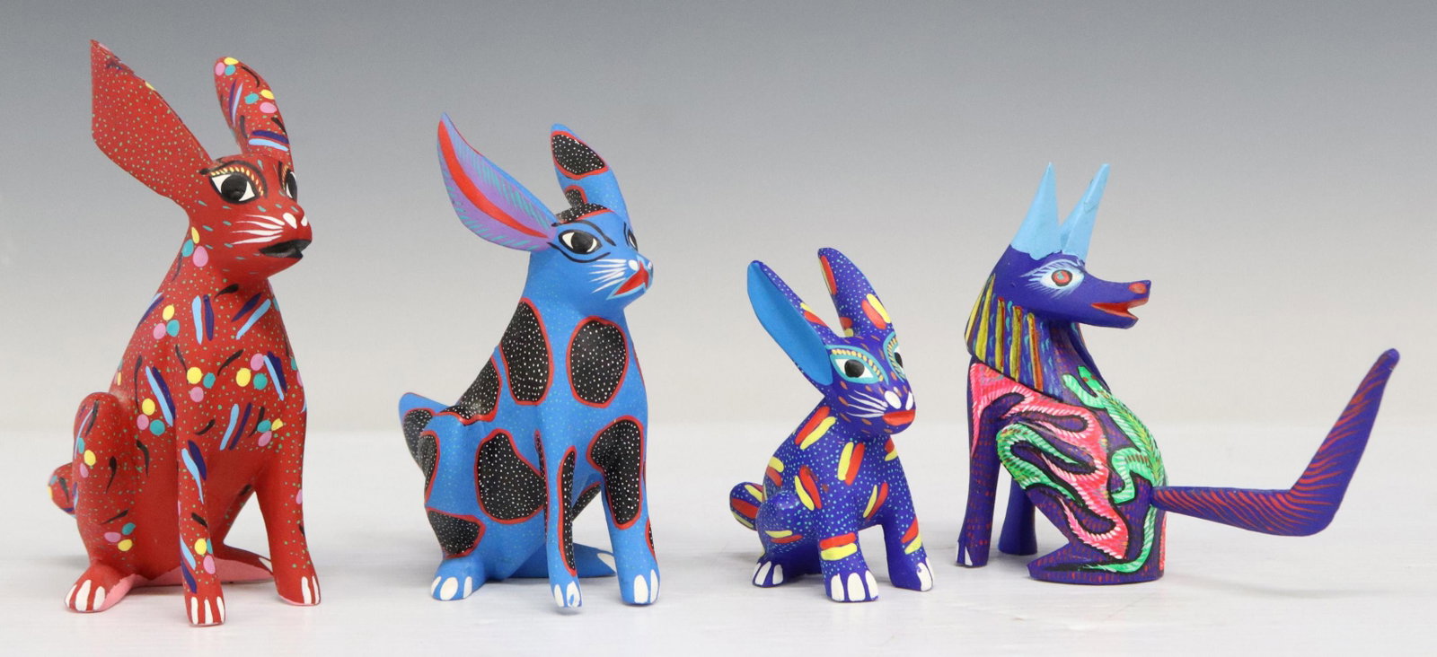 4) INES RIOS OAXACA MEXICO CARVED ALEBRIJE FIGURES: (lot of 4) Mexican folk art carved and painted wood alebrije figures, each signed Ines Rios D. (San Antonio Arrazola, Oaxaca, Mexico, 20th c.), including: (3) modeled as spotted rabbits, largest: appr