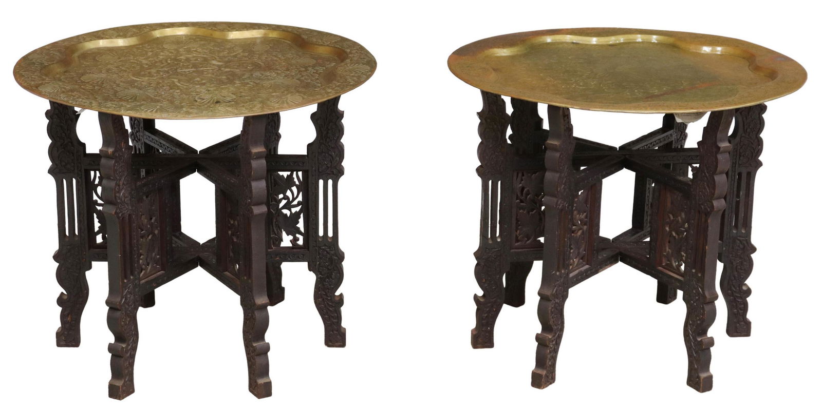 (2) FOLIATED METAL TRAY TOP TEA TABLES, INDIA: (pair) Tray-top tea tables, India, 20th c., round gilt-metal tray, incised pattern image with Peacocks, collapsible wood base with six foliate carved legs, overall: approx 24.25"h, 21"diam Start Price