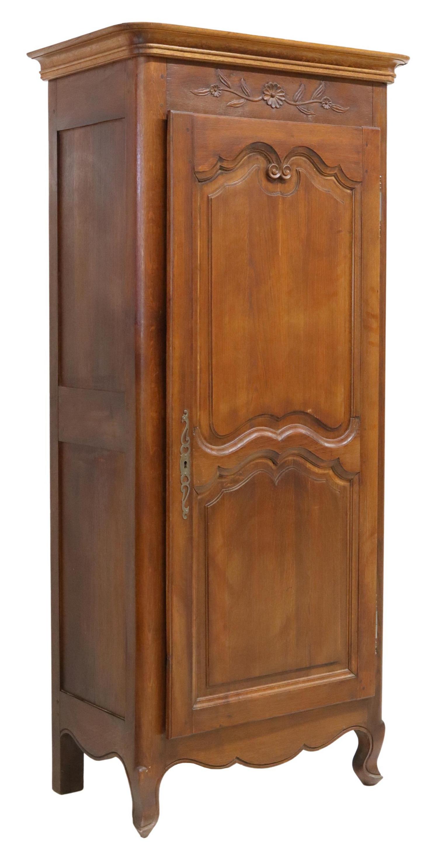 FRENCH PROVINCIAL CARVED OAK BONNETIERE: French Provincial oak bonnetiere, 20th c., molded cornice, floral-carved frieze, single paneled cabinet door on exterior hinges, interior shelves, scalloped apron, on short cabriole legs, approx 72.75