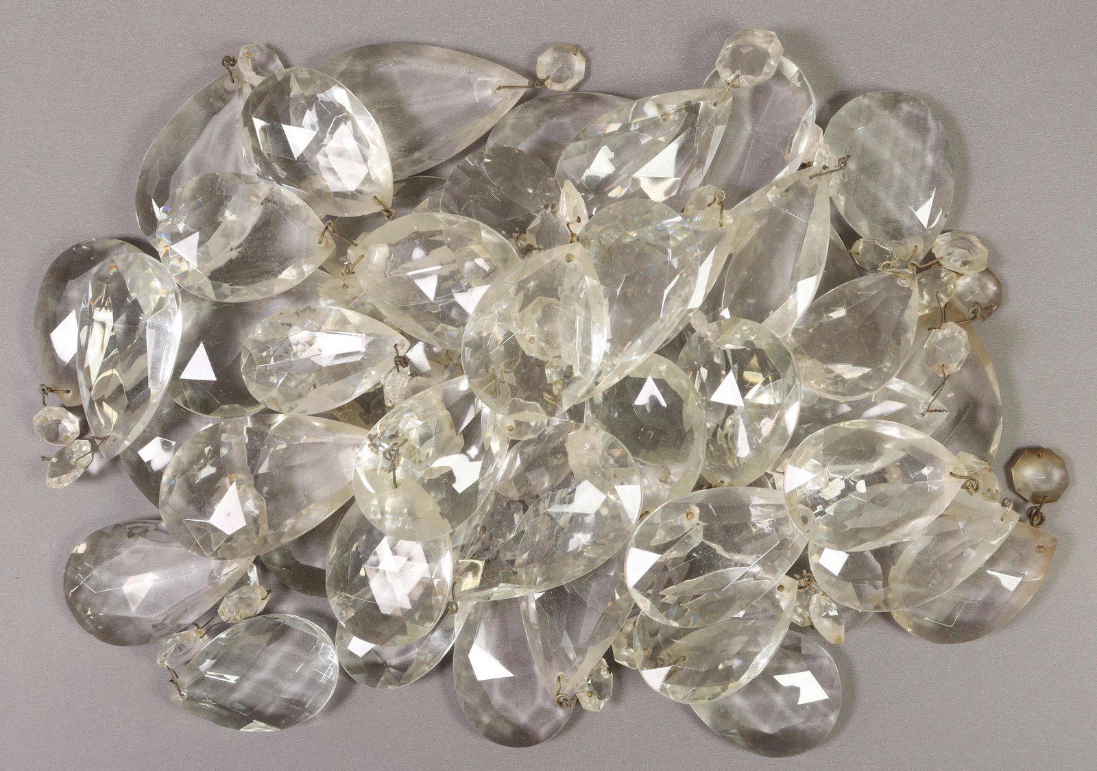 (LOT) ITALIAN CRYSTAL CHANDELIER DROPS & BEADS: (lot) Italian crystal chandelier drops, parts and pieces, including: faceted teardrop pendalogues, some with top bead, typical small chips, largest: approx 3"h, 2.25"w, 7.1lbs total Start Price: $80.0