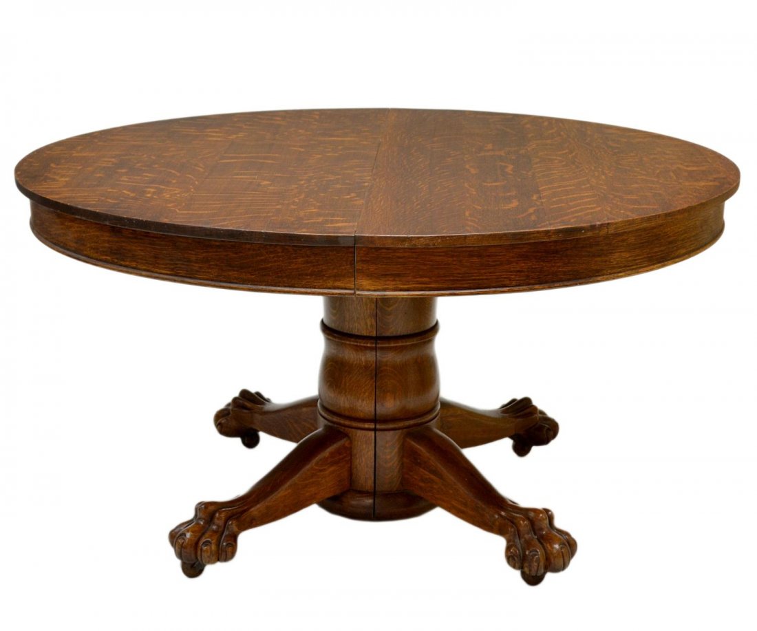 AMERICAN OAK ROUND 54" DINING TABLE, THREE LEAVES: American oak dining table, Hastings Table Company, Hastings, Michigan, c. 1910, a round top table with three 10" leaves resting on the split pedestal base with claw feet, 28.75"h, 54"d Start Price: $2
