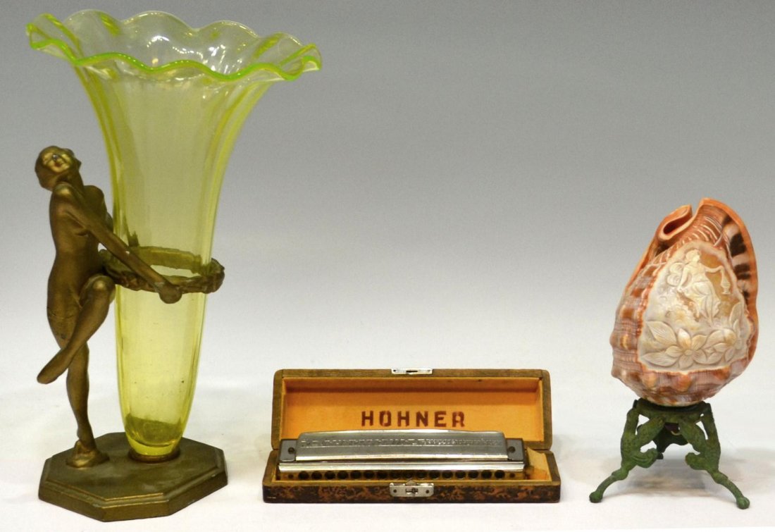 (3) VINTAGE LOT: CAMEO SHELL LAMP, VASE, HARMONICA: (lot of 3) A vintage cameo carved shell lamp, reserved with beauty in relief among clouds and flowers, rising on a verde metal tripod base, 8.5"h; together with (1) Art Deco figural metal and vaseline