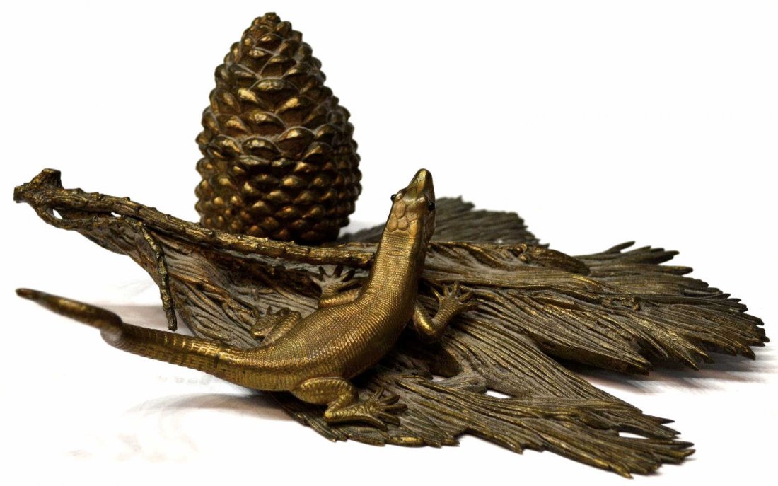 FINE ANTIQUE BRONZE LIZARD & PINE BRANCH INKWELL: Antique patinated bronze inkwell modeled as a lizard on a pine branch, the porcelain ink receptacle concealed in a pine cone, lizard with green cabochon eyes, excellent detail, 8.75"l, 6.5"w, 2lbs Sta