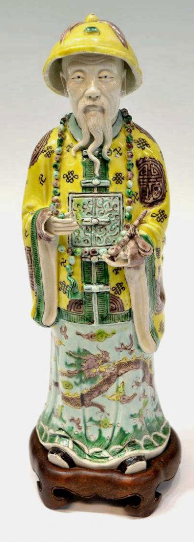 18TH C CHINESE BISCUIT MODEL OF A MANDARIN FIGURE: Chinese famille verte biscuit model of a Mandarin, Qing Dynasty, 18th c., colorful enamel decoration robe with dragon details, holding an opium pipe and prayer beads, some loss at beard, finger tips,