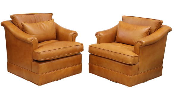 (2) LEATHER CLUB CHAIRS ON SWIVEL BASE: (pair) Leather club chairs, 20th c., having rolled arms, piping accents, each with throw pillow, rising on swivel base, approx 28.5"h, 32"w, 33"d, seat height: 18.75"h Start Price: $400.00