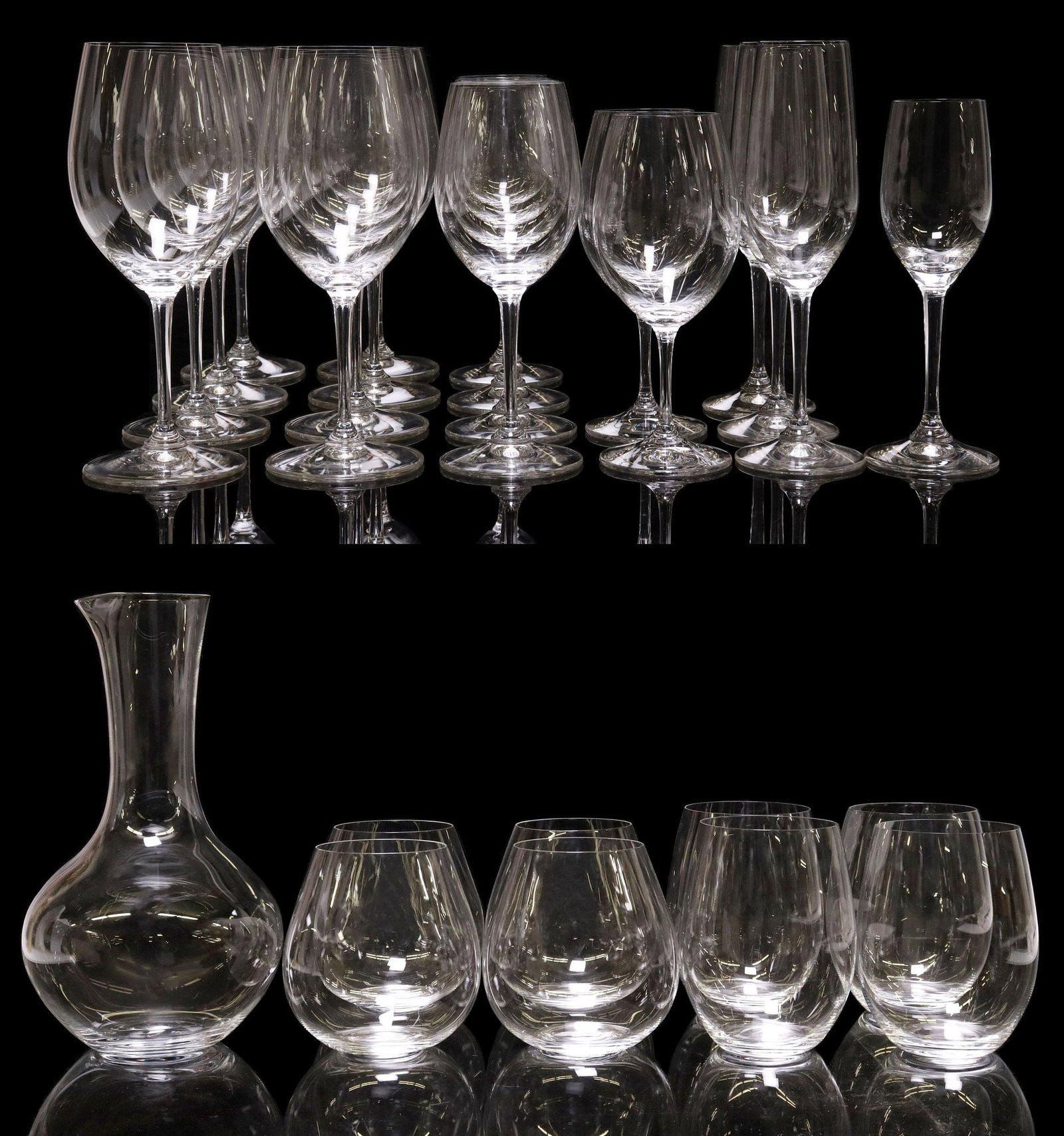 (27) RIEDEL COLORLESS GLASS STEMWARE & DECANTER: (lot of 27) Riedel colorless glass drinkware and decanter, all with acid-etched maker's mark underfoot, including: (8) red wine/ bordeaux stems, approx 8 7/8"h, 2.75"diam; (3) champagne flutes, approx