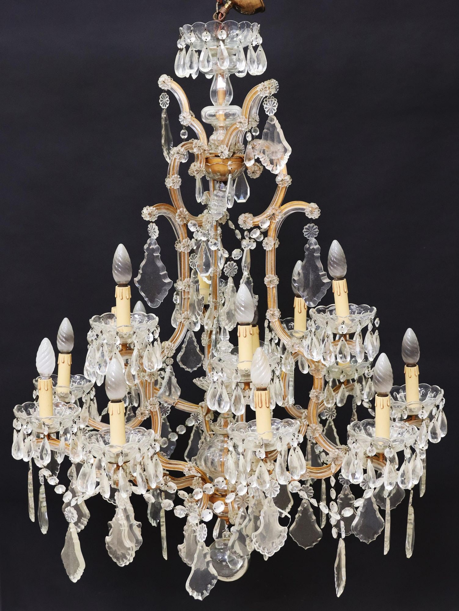 ITALIAN MARIA THERESA STYLE 15-LIGHT CHANDELIER: Italian Maria Theresa style fifteen-light chandelier, having two tiers, central finial, issuing glass-clad scrolling arms, terminating in floriform bobeches, hung with crystal prisms and pendalogues t