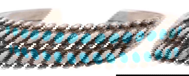NATIVE AMERICAN SILVER & TURQUOISE CUFF BRACELET: Native American silver (content unknown) two-prong cuff bracelet, with inset petit point turquoise, beaded border, stamp work detail, approx .50"w, interior: approx 5.25"l, gap: approx 7/8"w, 23.7 Sta