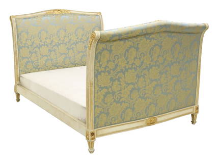 FRENCH LOUIS XVI STYLE UPHOLSTERED ALCOVE BED: French Louis XVI style alcove bed, 20th c., having white and gilt painted wood frame, in later floral patterned upholstery, with ribbon trim, rising on squared and tapered supports, accompanied by con